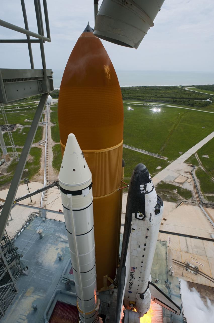 CAPE CANAVERAL, Fla. -- The engines begin to rumble beneath space shuttle Atlantis on Launch Pad 39A at NASA's Kennedy Space Center in Florida.  Atlantis began its final flight, the STS-135 mission to the International Space Station, at 11:29 a.m. EDT July 8.    STS-135 will deliver the Raffaello multi-purpose logistics module packed with supplies and spare parts to the orbiting laboratory. Atlantis also is flying the Robotic Refueling Mission experiment that will investigate the potential for robotically refueling existing satellites in orbit. In addition, a failed ammonia pump module will be returned to Earth aboard Atlantis to help NASA better understand the failure mechanism and improve pump designs for future systems. STS-135 is the 33rd flight of Atlantis, the 37th shuttle mission to the space station, and the 135th and final mission of NASA's Space Shuttle Program. For more information, visit www.nasa.gov/mission_pages/shuttle/shuttlemissions/sts135/index.html. Photo credit: NASA/Tony Gray and Tom Farrar