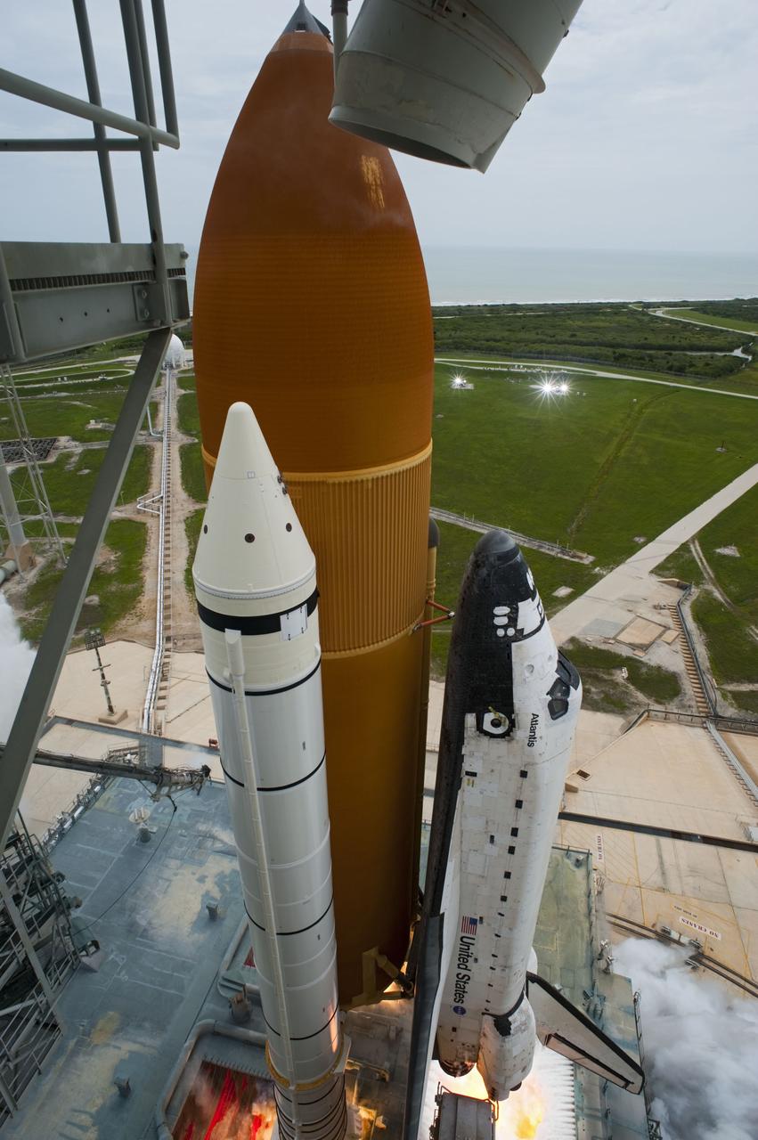 CAPE CANAVERAL, Fla. -- The engines roar to life beneath space shuttle Atlantis heralding liftoff from Launch Pad 39A at NASA's Kennedy Space Center in Florida.  Atlantis began its final flight, the STS-135 mission to the International Space Station, at 11:29 a.m. EDT July 8.    STS-135 will deliver the Raffaello multi-purpose logistics module packed with supplies and spare parts to the orbiting laboratory. Atlantis also is flying the Robotic Refueling Mission experiment that will investigate the potential for robotically refueling existing satellites in orbit. In addition, a failed ammonia pump module will be returned to Earth aboard Atlantis to help NASA better understand the failure mechanism and improve pump designs for future systems. STS-135 is the 33rd flight of Atlantis, the 37th shuttle mission to the space station, and the 135th and final mission of NASA's Space Shuttle Program. For more information, visit www.nasa.gov/mission_pages/shuttle/shuttlemissions/sts135/index.html. Photo credit: NASA/Tony Gray and Tom Farrar