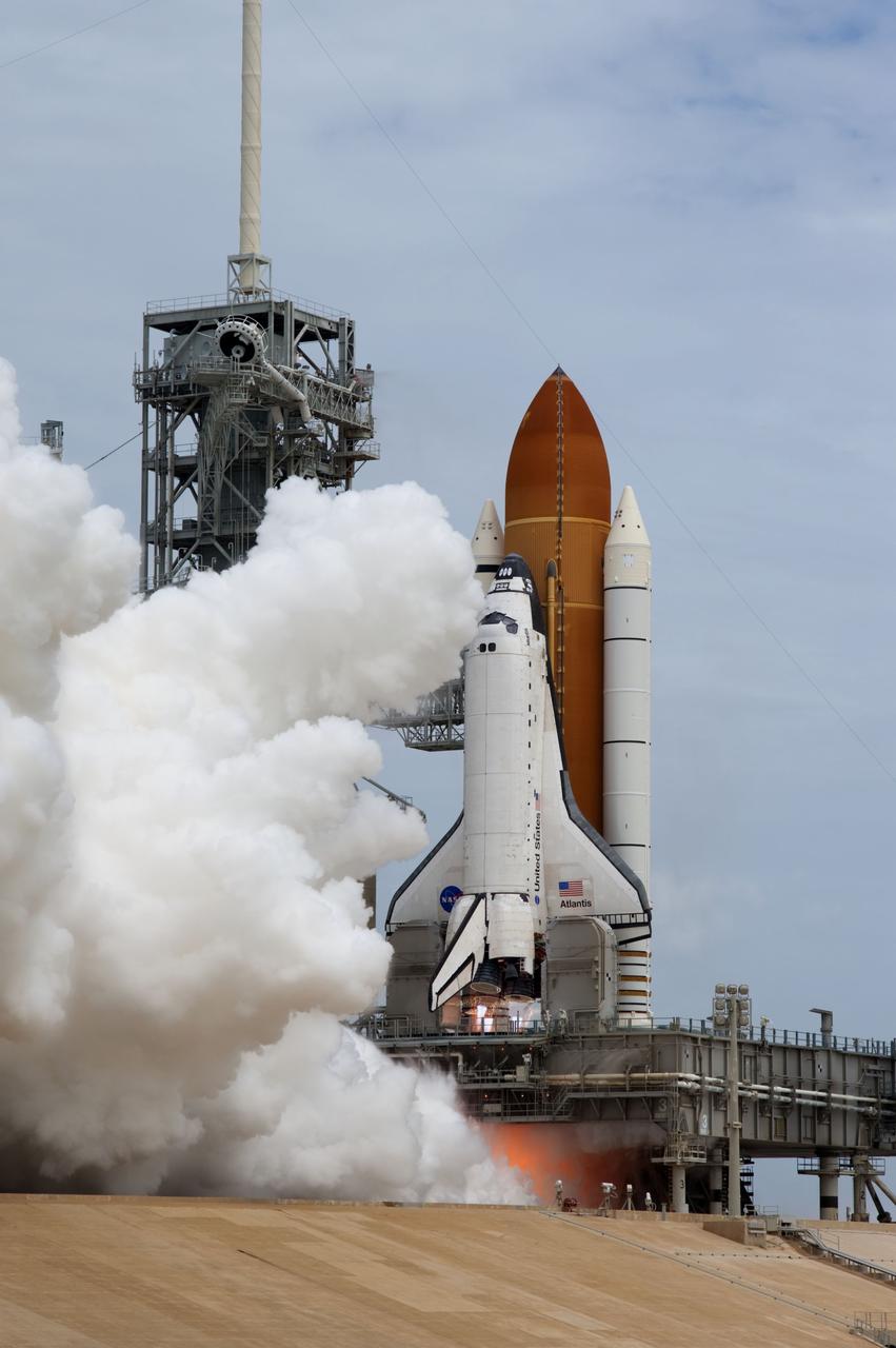 CAPE CANAVERAL, Fla. -- At NASA's Kennedy Space Center in Florida, space shuttle Atlantis' main engines and solid rocket boosters ignite on Launch Pad 39A producing billows of smoke and steam as it lifts off on its STS-135 mission to the International Space Station.    Atlantis with its crew of four; Commander Chris Ferguson, Pilot Doug Hurley, Mission Specialists Sandy Magnus and Rex Walheim, lifted off at 11:29 a.m. EDT on July 8, 2011 to deliver the Raffaello multi-purpose logistics module packed with supplies and spare parts for the station. Atlantis also will fly the Robotic Refueling Mission experiment that will investigate the potential for robotically refueling existing satellites in orbit. In addition, Atlantis will return with a failed ammonia pump module to help NASA better understand the failure mechanism and improve pump designs for future systems. STS-135 is the 33rd flight of Atlantis, the 37th shuttle mission to the space station, and the 135th and final mission of NASA's Space Shuttle Program. For more information, visit www.nasa.gov/mission_pages/shuttle/shuttlemissions/sts135/index.html. Photo credit: NASA/Sandra Joseph and Kevin O'Connell