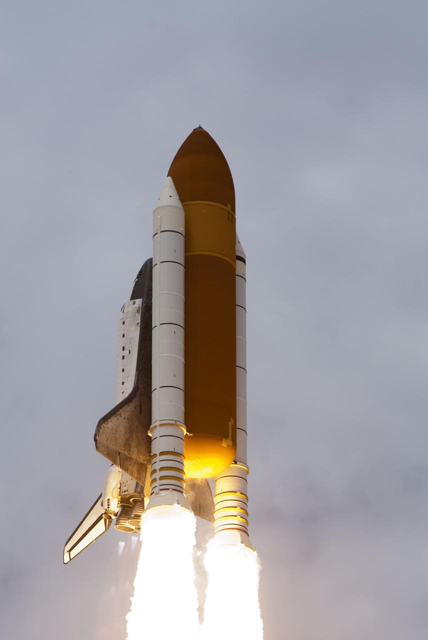 CAPE CANAVERAL, Fla. -- At Launch Pad 39A at NASA's Kennedy Space Center in Florida, space shuttle Atlantis soars into the clouds on its STS-135 mission to the International Space Station.          Atlantis with its crew of four; Commander Chris Ferguson, Pilot Doug Hurley, Mission Specialists Sandy Magnus and Rex Walheim, lifted off at 11:29 a.m. EDT on July 8, 2011 to deliver the Raffaello multi-purpose logistics module packed with supplies and spare parts for the station. Atlantis also will fly the Robotic Refueling Mission experiment that will investigate the potential for robotically refueling existing satellites in orbit. In addition, Atlantis will return with a failed ammonia pump module to help NASA better understand the failure mechanism and improve pump designs for future systems. STS-135 is the 33rd flight of Atlantis, the 37th shuttle mission to the space station, and the 135th and final mission of NASA's Space Shuttle Program. For more information, visit www.nasa.gov/mission_pages/shuttle/shuttlemissions/sts135/index.html. Photo credit: NASA/Rusty Backer and Mike Gayle