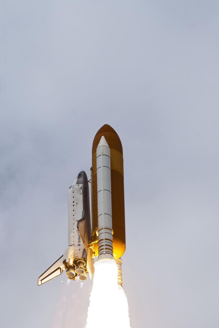 CAPE CANAVERAL, Fla. -- At Launch Pad 39A at NASA's Kennedy Space Center in Florida, space shuttle Atlantis soars into the clouds on its STS-135 mission to the International Space Station.          Atlantis with its crew of four; Commander Chris Ferguson, Pilot Doug Hurley, Mission Specialists Sandy Magnus and Rex Walheim, lifted off at 11:29 a.m. EDT on July 8, 2011 to deliver the Raffaello multi-purpose logistics module packed with supplies and spare parts for the station. Atlantis also will fly the Robotic Refueling Mission experiment that will investigate the potential for robotically refueling existing satellites in orbit. In addition, Atlantis will return with a failed ammonia pump module to help NASA better understand the failure mechanism and improve pump designs for future systems. STS-135 is the 33rd flight of Atlantis, the 37th shuttle mission to the space station, and the 135th and final mission of NASA's Space Shuttle Program. For more information, visit www.nasa.gov/mission_pages/shuttle/shuttlemissions/sts135/index.html. Photo credit: NASA/Rusty Backer and Mike Gayle