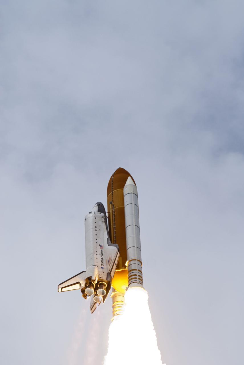 CAPE CANAVERAL, Fla. -- At Launch Pad 39A at NASA's Kennedy Space Center in Florida, space shuttle Atlantis soars into the clouds on its STS-135 mission to the International Space Station.          Atlantis with its crew of four; Commander Chris Ferguson, Pilot Doug Hurley, Mission Specialists Sandy Magnus and Rex Walheim, lifted off at 11:29 a.m. EDT on July 8, 2011 to deliver the Raffaello multi-purpose logistics module packed with supplies and spare parts for the station. Atlantis also will fly the Robotic Refueling Mission experiment that will investigate the potential for robotically refueling existing satellites in orbit. In addition, Atlantis will return with a failed ammonia pump module to help NASA better understand the failure mechanism and improve pump designs for future systems. STS-135 is the 33rd flight of Atlantis, the 37th shuttle mission to the space station, and the 135th and final mission of NASA's Space Shuttle Program. For more information, visit www.nasa.gov/mission_pages/shuttle/shuttlemissions/sts135/index.html. Photo credit: NASA/Rusty Backer and Mike Gayle