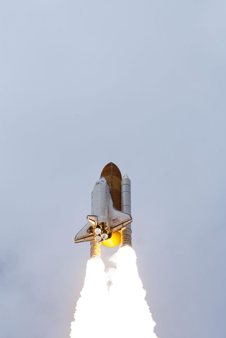 CAPE CANAVERAL, Fla. -- At Launch Pad 39A at NASA's Kennedy Space Center in Florida, space shuttle Atlantis soars into the clouds on its STS-135 mission to the International Space Station.          Atlantis with its crew of four; Commander Chris Ferguson, Pilot Doug Hurley, Mission Specialists Sandy Magnus and Rex Walheim, lifted off at 11:29 a.m. EDT on July 8, 2011 to deliver the Raffaello multi-purpose logistics module packed with supplies and spare parts for the station. Atlantis also will fly the Robotic Refueling Mission experiment that will investigate the potential for robotically refueling existing satellites in orbit. In addition, Atlantis will return with a failed ammonia pump module to help NASA better understand the failure mechanism and improve pump designs for future systems. STS-135 is the 33rd flight of Atlantis, the 37th shuttle mission to the space station, and the 135th and final mission of NASA's Space Shuttle Program. For more information, visit www.nasa.gov/mission_pages/shuttle/shuttlemissions/sts135/index.html. Photo credit: NASA/Rusty Backer and Mike Gayle