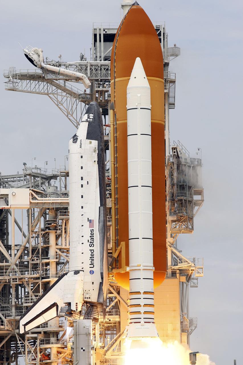 CAPE CANAVERAL, Fla. -- At NASA's Kennedy Space Center in Florida, space shuttle Atlantis' main engines ignite and solid rocket boosters ignite on Launch Pad 39A leaving behind a twin stream of flame as it lifts off on its STS-135 mission to the International Space Station.    Atlantis with its crew of four; Commander Chris Ferguson, Pilot Doug Hurley, Mission Specialists Sandy Magnus and Rex Walheim, lifted off at 11:29 a.m. EDT on July 8, 2011 to deliver the Raffaello multi-purpose logistics module packed with supplies and spare parts for the International Space Station. Atlantis also will fly the Robotic Refueling Mission experiment that will investigate the potential for robotically refueling existing satellites in orbit. In addition, Atlantis will return with a failed ammonia pump module to help NASA better understand the failure mechanism and improve pump designs for future systems. STS-135 is the 33rd flight of Atlantis, the 37th shuttle mission to the space station, and the 135th and final mission of NASA's Space Shuttle Program. For more information, visit www.nasa.gov/mission_pages/shuttle/shuttlemissions/sts135/index.html. Photo credit: NASA/Rusty Backer and Mike Gayle