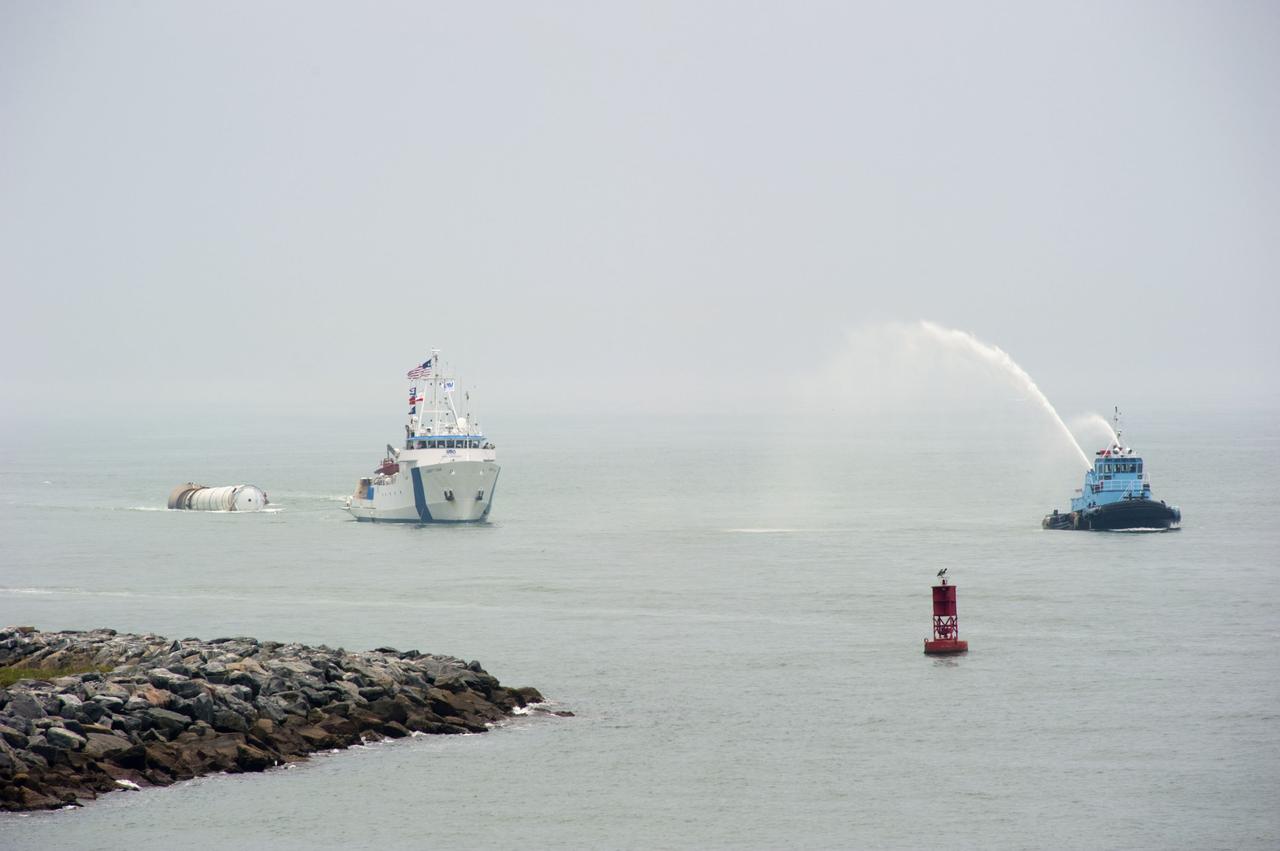 CAPE CANAVERAL, Fla. -- Liberty Star, one of NASA's solid rocket booster retrieval ships, tows a spent booster from space shuttle Atlantis' final launch, to Port Canaveral in Florida. A Cape Canaveral Port Authority tug sends a spray of water through its cannon as a welcome back to the Port. The shuttle's two solid rocket booster casings and associated flight hardware are recovered in the Atlantic Ocean after every launch by Freedom Star and Liberty Star. The boosters impact the Atlantic about seven minutes after liftoff and the retrieval ships are stationed about 10 miles from the impact area at the time of splashdown. After the spent segments are processed, they will be transported to Utah, where they will be deserviced and stored, if needed. Atlantis began its final flight at 11:29 a.m. EDT on July 8 to deliver the Raffaello multi-purpose logistics module packed with supplies and spare parts for the International Space Station. Atlantis also delivers the Robotic Refueling Mission experiment that will investigate the potential for robotically refueling existing satellites in orbit to the station. In addition, Atlantis will return with a failed ammonia pump module to help NASA better understand the failure mechanism and improve pump designs for future systems. STS-135 is the 33rd flight of Atlantis, the 37th shuttle mission to the space station, and the 135th and final mission of NASA's Space Shuttle Program. For more information, visit www.nasa.gov/mission_pages/shuttle/shuttlemissions/sts135/index.html. Photo credit: NASA/Kim Shiflett