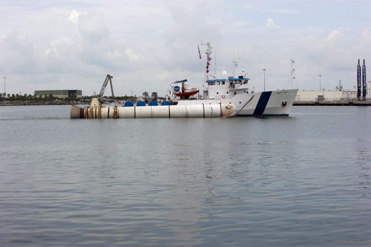 CAPE CANAVERAL, Fla. -- Liberty Star, one of NASA's solid rocket booster retrieval ships, tows a spent booster from space shuttle Atlantis' final launch, to Port Canaveral in Florida.  The shuttle's two solid rocket booster casings and associated flight hardware are recovered in the Atlantic Ocean after every launch by Freedom Star and Liberty Star. The boosters impact the Atlantic about seven minutes after liftoff and the retrieval ships are stationed about 10 miles from the impact area at the time of splashdown. After the spent segments are processed, they will be transported to Utah, where they will be deserviced and stored, if needed.        Atlantis began its final flight at 11:29 a.m. EDT on July 8. STS-135 to deliver the Raffaello multi-purpose logistics module packed with supplies and spare parts for the International Space Station. Atlantis also delivers the Robotic Refueling Mission experiment that will investigate the potential for robotically refueling existing satellites in orbit to the station. In addition, Atlantis will return with a failed ammonia pump module to help NASA better understand the failure mechanism and improve pump designs for future systems. STS-135 is the 33rd flight of Atlantis, the 37th shuttle mission to the space station, and the 135th and final mission of NASA's Space Shuttle Program. For more information, visit www.nasa.gov/mission_pages/shuttle/shuttlemissions/sts135/index.html. Photo credit: NASA/Kim Shiflett