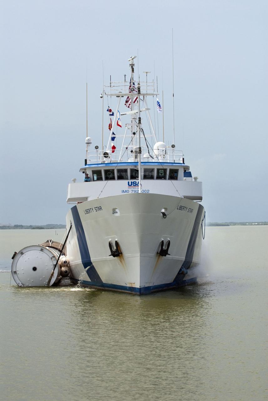 CAPE CANAVERAL, Fla. -- Liberty Star, one of NASA's solid rocket booster retrieval ships, tows a spent booster from space shuttle Atlantis' final launch, to Port Canaveral in Florida.  The shuttle's two solid rocket booster casings and associated flight hardware are recovered in the Atlantic Ocean after every launch by Freedom Star and Liberty Star. The boosters impact the Atlantic about seven minutes after liftoff and the retrieval ships are stationed about 10 miles from the impact area at the time of splashdown. After the spent segments are processed, they will be transported to Utah, where they will be deserviced and stored, if needed.        Atlantis began its final flight at 11:29 a.m. EDT on July 8 to deliver the Raffaello multi-purpose logistics module packed with supplies and spare parts for the International Space Station. Atlantis also delivers the Robotic Refueling Mission experiment that will investigate the potential for robotically refueling existing satellites in orbit to the station. In addition, Atlantis will return with a failed ammonia pump module to help NASA better understand the failure mechanism and improve pump designs for future systems. STS-135 is the 33rd flight of Atlantis, the 37th shuttle mission to the space station, and the 135th and final mission of NASA's Space Shuttle Program. For more information, visit www.nasa.gov/mission_pages/shuttle/shuttlemissions/sts135/index.html. Photo credit: NASA/Kim Shiflett