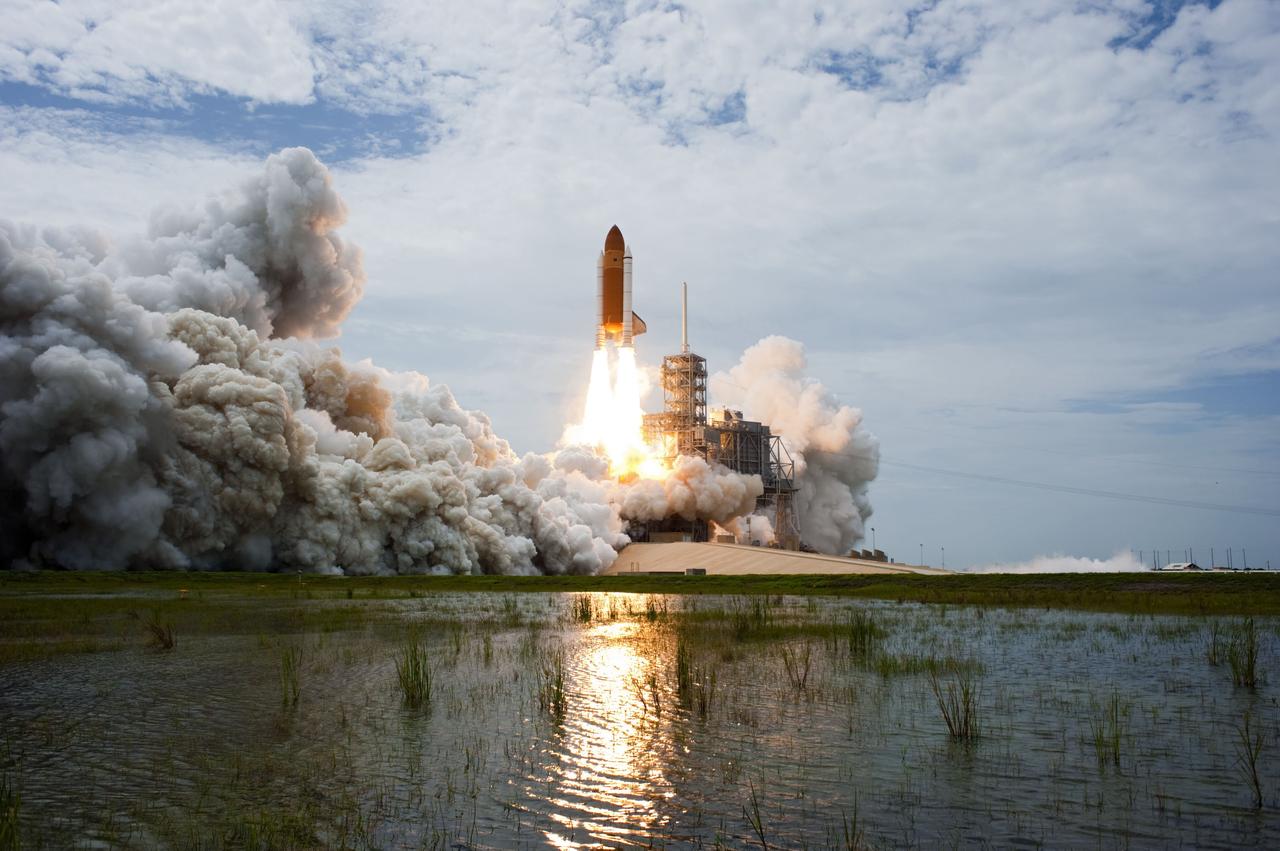 CAPE CANAVERAL, Fla. -- At NASA's Kennedy Space Center in Florida, space shuttle Atlantis lifts off of Launch Pad 39A leaving behind  billows of steam and smoke as it heads upwards past the tower on its STS-135 mission to the International Space Station.      Atlantis with its crew of four; Commander Chris Ferguson, Pilot Doug Hurley, Mission Specialists Sandy Magnus and Rex Walheim, lifted off at 11:29 a.m. EDT on July 8, 2011 to deliver the Raffaello multi-purpose logistics module packed with supplies and spare parts for the station. Atlantis also will fly the Robotic Refueling Mission experiment that will investigate the potential for robotically refueling existing satellites in orbit. In addition, Atlantis will return with a failed ammonia pump module to help NASA better understand the failure mechanism and improve pump designs for future systems. STS-135 is the 33rd flight of Atlantis, the 37th shuttle mission to the space station, and the 135th and final mission of NASA's Space Shuttle Program. For more information, visit www.nasa.gov/mission_pages/shuttle/shuttlemissions/sts135/index.html. Photo credit: NASA/Sandra Joseph and Kevin O'Connell