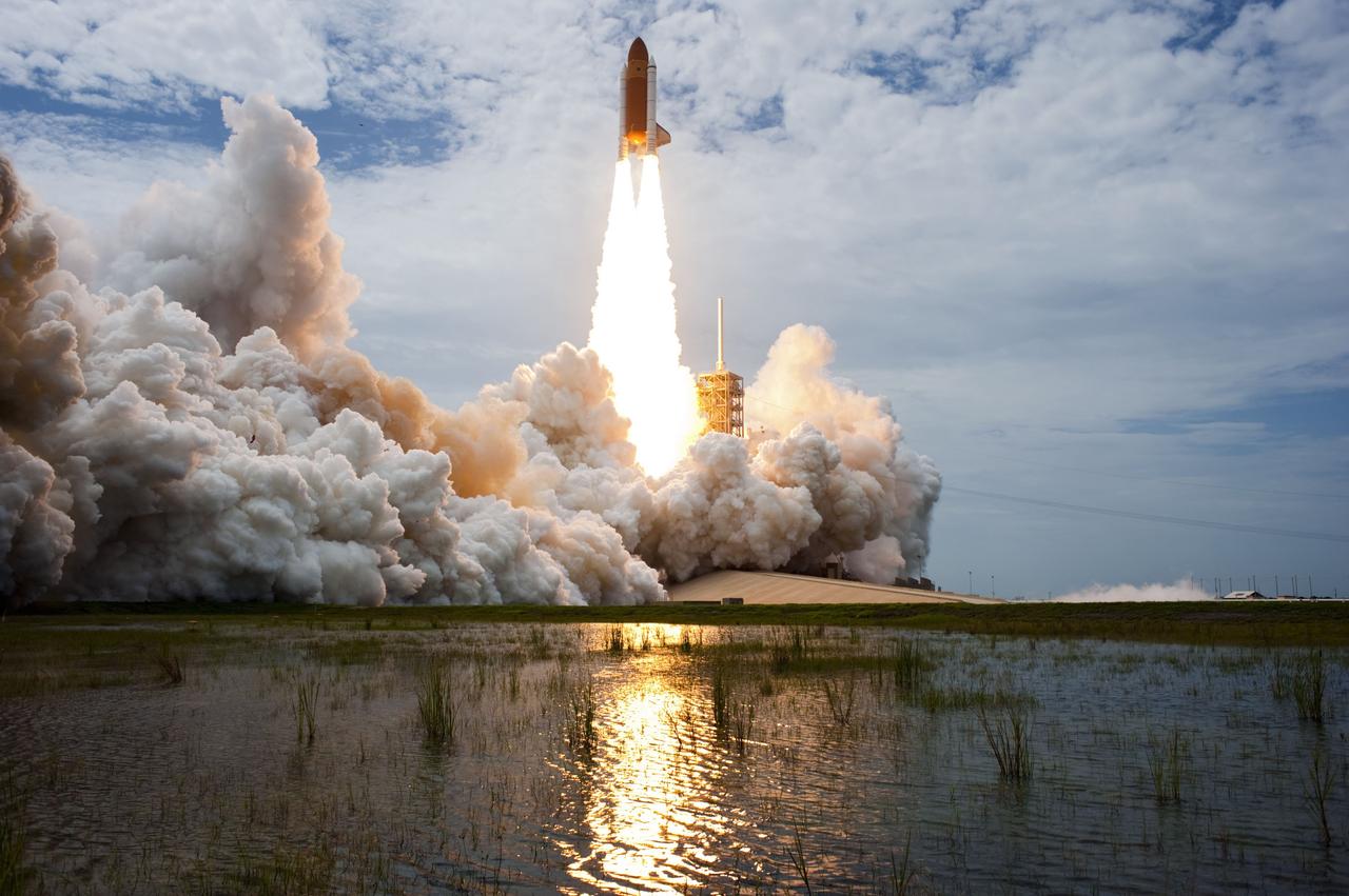 CAPE CANAVERAL, Fla. -- At NASA's Kennedy Space Center in Florida, space shuttle Atlantis lifts off of Launch Pad 39A leaving behind  billows of steam and smoke as it heads into the clouds on its STS-135 mission to the International Space Station.        Atlantis with its crew of four; Commander Chris Ferguson, Pilot Doug Hurley, Mission Specialists Sandy Magnus and Rex Walheim, lifted off at 11:29 a.m. EDT on July 8, 2011 to deliver the Raffaello multi-purpose logistics module packed with supplies and spare parts for the station. Atlantis also will fly the Robotic Refueling Mission experiment that will investigate the potential for robotically refueling existing satellites in orbit. In addition, Atlantis will return with a failed ammonia pump module to help NASA better understand the failure mechanism and improve pump designs for future systems. STS-135 is the 33rd flight of Atlantis, the 37th shuttle mission to the space station, and the 135th and final mission of NASA's Space Shuttle Program. For more information, visit www.nasa.gov/mission_pages/shuttle/shuttlemissions/sts135/index.html. Photo credit: NASA/Sandra Joseph and Kevin O'Connell