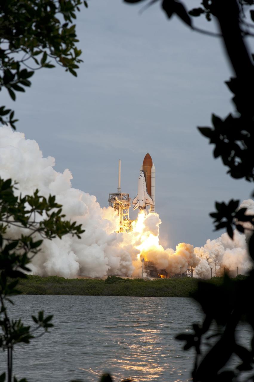 CAPE CANAVERAL, Fla. -- At NASA's Kennedy Space Center in Florida, space shuttle Atlantis lifts off of Launch Pad 39A leaving behind billows of steam and smoke as it heads upwards past the tower on its STS-135 mission to the International Space Station. Atlantis with its crew of four; Commander Chris Ferguson, Pilot Doug Hurley, Mission Specialists Sandy Magnus and Rex Walheim, lifted off at 11:29 a.m. EDT on July 8, 2011 to deliver the Raffaello multi-purpose logistics module packed with supplies and spare parts for the International Space Station. Atlantis also will fly the Robotic Refueling Mission experiment that will investigate the potential for robotically refueling existing satellites in orbit. In addition, Atlantis will return with a failed ammonia pump module to help NASA better understand the failure mechanism and improve pump designs for future systems. STS-135 is the 33rd flight of Atlantis, the 37th shuttle mission to the space station, and the 135th and final mission of NASA's Space Shuttle Program. For more information, visit www.nasa.gov/mission_pages/shuttle/shuttlemissions/sts135/index.html. Photo credit: NASA/Sandra Joseph and Kevin O'Connell