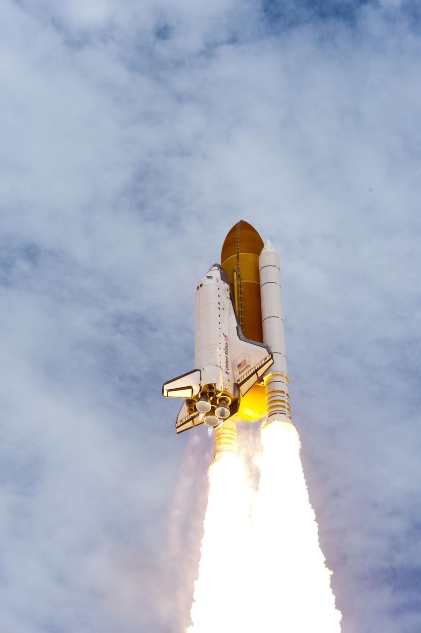 CAPE CANAVERAL, Fla. -- Solid rocket motors blazing, space shuttle Atlantis heads into the clouds over Launch Pad 39A at NASA's Kennedy Space Center in Florida.  Atlantis began its final flight, the STS-135 mission to the International Space Station, at 11:29 a.m. EDT July 8.    STS-135 will deliver the Raffaello multi-purpose logistics module packed with supplies and spare parts to the orbiting laboratory. Atlantis also is flying the Robotic Refueling Mission experiment that will investigate the potential for robotically refueling existing satellites in orbit. In addition, a failed ammonia pump module will be returned to Earth aboard Atlantis to help NASA better understand the failure mechanism and improve pump designs for future systems. STS-135 is the 33rd flight of Atlantis, the 37th shuttle mission to the space station, and the 135th and final mission of NASA's Space Shuttle Program. For more information, visit www.nasa.gov/mission_pages/shuttle/shuttlemissions/sts135/index.html. Photo credit: NASA/Tony Gray and Tom Farrar
