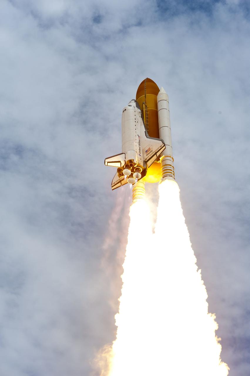 CAPE CANAVERAL, Fla. -- Solid rocket motors blazing, space shuttle Atlantis heads into the cloud-laden sky over Launch Pad 39A at NASA's Kennedy Space Center in Florida.  Atlantis began its final flight, the STS-135 mission to the International Space Station, at 11:29 a.m. EDT July 8.    STS-135 will deliver the Raffaello multi-purpose logistics module packed with supplies and spare parts to the orbiting laboratory. Atlantis also is flying the Robotic Refueling Mission experiment that will investigate the potential for robotically refueling existing satellites in orbit. In addition, a failed ammonia pump module will be returned to Earth aboard Atlantis to help NASA better understand the failure mechanism and improve pump designs for future systems. STS-135 is the 33rd flight of Atlantis, the 37th shuttle mission to the space station, and the 135th and final mission of NASA's Space Shuttle Program. For more information, visit www.nasa.gov/mission_pages/shuttle/shuttlemissions/sts135/index.html. Photo credit: NASA/Tony Gray and Tom Farrar