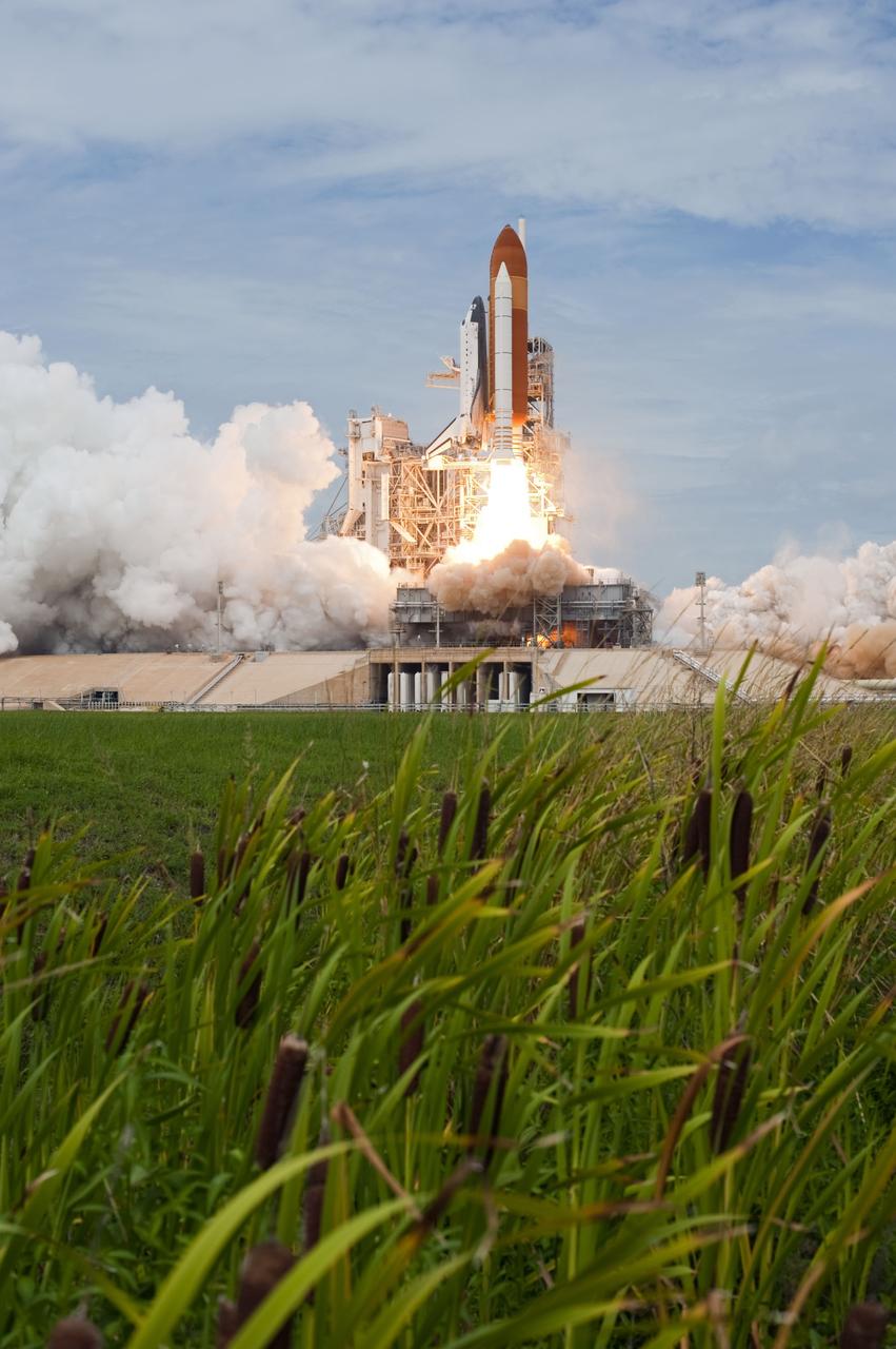 CAPE CANAVERAL, Fla. -- On Launch Pad 39A at NASA's Kennedy Space Center in Florida, space shuttle Atlantis travels upward on streams of flame as it lifts off on its STS-135 mission to the International Space Station.          Atlantis with its crew of four; Commander Chris Ferguson, Pilot Doug Hurley, Mission Specialists Sandy Magnus and Rex Walheim, lifted off at 11:29 a.m. EDT on July 8, 2011 to deliver the Raffaello multi-purpose logistics module packed with supplies and spare parts for the station. Atlantis also will fly the Robotic Refueling Mission experiment that will investigate the potential for robotically refueling existing satellites in orbit. In addition, Atlantis will return with a failed ammonia pump module to help NASA better understand the failure mechanism and improve pump designs for future systems. STS-135 is the 33rd flight of Atlantis, the 37th shuttle mission to the space station, and the 135th and final mission of NASA's Space Shuttle Program. For more information, visit www.nasa.gov/mission_pages/shuttle/shuttlemissions/sts135/index.html. Photo credit: NASA/Tony Gray and Tom Farrar