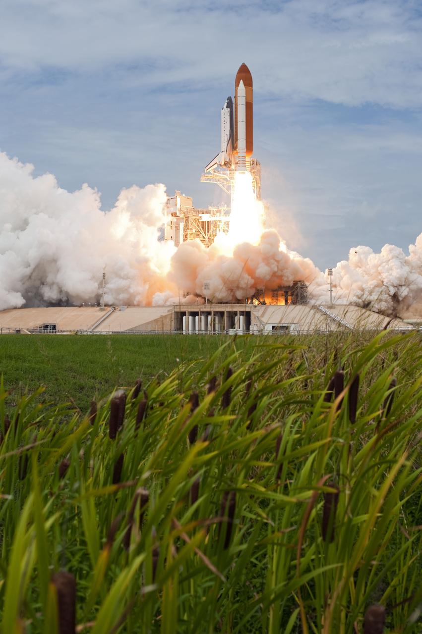 CAPE CANAVERAL, Fla. -- On Launch Pad 39A at NASA's Kennedy Space Center in Florida, space shuttle Atlantis travels upward on streams of flame as it lifts off on its STS-135 mission to the International Space Station.          Atlantis with its crew of four; Commander Chris Ferguson, Pilot Doug Hurley, Mission Specialists Sandy Magnus and Rex Walheim, lifted off at 11:29 a.m. EDT on July 8, 2011 to deliver the Raffaello multi-purpose logistics module packed with supplies and spare parts for the station. Atlantis also will fly the Robotic Refueling Mission experiment that will investigate the potential for robotically refueling existing satellites in orbit. In addition, Atlantis will return with a failed ammonia pump module to help NASA better understand the failure mechanism and improve pump designs for future systems. STS-135 is the 33rd flight of Atlantis, the 37th shuttle mission to the space station, and the 135th and final mission of NASA's Space Shuttle Program. For more information, visit www.nasa.gov/mission_pages/shuttle/shuttlemissions/sts135/index.html. Photo credit: NASA/Tony Gray and Tom Farrar