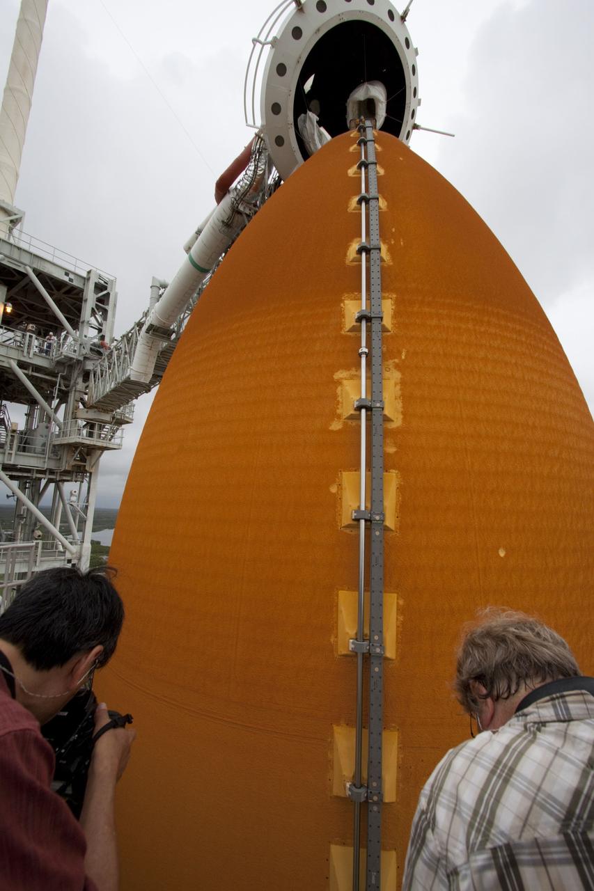 CAPE CANAVERAL, Fla. – Photographers Stan Hernda of AFP News, left, and Scott Andrews of Canon record space shuttle Atlantis as it is revealed on Launch Pad 39A at NASA's Kennedy Space Center in Florida following the move of the rotating service structure (RSS). The structure provides weather protection and access to the shuttle while it awaits liftoff on the pad. RSS "rollback" marks a major milestone in Atlantis' STS-135 mission countdown. Atlantis and its crew of four; Commander Chris Ferguson, Pilot Doug Hurley and Mission Specialists Sandy Magnus and Rex Walheim, are scheduled to lift off at 11:26 a.m. EDT on July 8 to deliver the Raffaello multi-purpose logistics module packed with supplies and spare parts to the International Space Station. Atlantis also will fly the Robotic Refueling Mission experiment that will investigate the potential for robotically refueling existing satellites in orbit. In addition, Atlantis will return with a failed ammonia pump module to help NASA better understand the failure mechanism and improve pump designs for future systems. STS-135 will be the 33rd flight of Atlantis, the 37th shuttle mission to the space station, and the 135th and final mission of NASA's Space Shuttle Program. For more information visit, www.nasa.gov/mission_pages/shuttle/shuttlemissions/sts135/index.html. Photo credit: NASA/Ken Thornsley