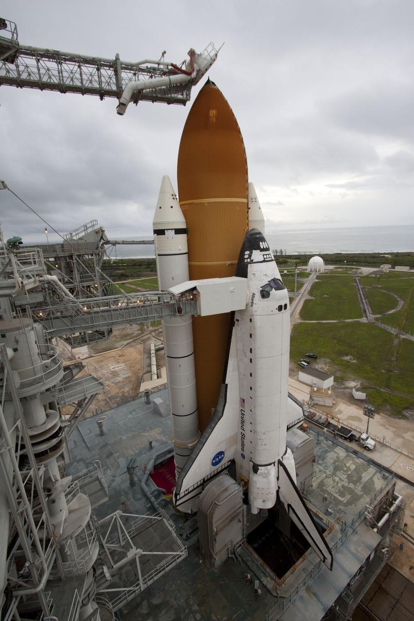 CAPE CANAVERAL, Fla. -- Space shuttle Atlantis is revealed on Launch Pad 39A at NASA's Kennedy Space Center in Florida following the move of the rotating service structure (RSS). The structure provides weather protection and access to the shuttle while it awaits liftoff on the pad. RSS "rollback" marks a major milestone in Atlantis' STS-135 mission countdown. Atlantis and its crew of four; Commander Chris Ferguson, Pilot Doug Hurley and Mission Specialists Sandy Magnus and Rex Walheim, are scheduled to lift off at 11:26 a.m. EDT on July 8 to deliver the Raffaello multi-purpose logistics module packed with supplies and spare parts to the International Space Station. Atlantis also will fly the Robotic Refueling Mission experiment that will investigate the potential for robotically refueling existing satellites in orbit. In addition, Atlantis will return with a failed ammonia pump module to help NASA better understand the failure mechanism and improve pump designs for future systems. STS-135 will be the 33rd flight of Atlantis, the 37th shuttle mission to the space station, and the 135th and final mission of NASA's Space Shuttle Program. For more information visit, www.nasa.gov/mission_pages/shuttle/shuttlemissions/sts135/index.html. Photo credit: NASA/Ken Thornsley