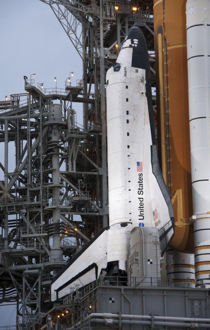 CAPE CANAVERAL, Fla. -- At NASA's Kennedy Space Center, space shuttle Atlantis can be seen in the distance awaiting liftoff on its STS-135 mission while members of the media set up cameras to capture the launch on a very rainy day in Florida.        Atlantis and its crew of four; Commander Chris Ferguson, Pilot Doug Hurley, Mission Specialists Sandy Magnus and Rex Walheim are scheduled to lift off at 11:26 a.m. EDT on July 8 to deliver the Raffaello multi-purpose logistics module packed with supplies and spare parts for the International Space Station. Atlantis also will fly the Robotic Refueling Mission experiment that will investigate the potential for robotically refueling existing satellites in orbit. In addition, Atlantis will return with a failed ammonia pump module to help NASA better understand the failure mechanism and improve pump designs for future systems. STS-135 is the 33rd flight of Atlantis, the 37th shuttle mission to the space station, and the 135th and final mission of NASA's Space Shuttle Program. For more information, visit www.nasa.gov/mission_pages/shuttle/shuttlemissions/sts135/index.html. Photo credit: Ken Thornsley