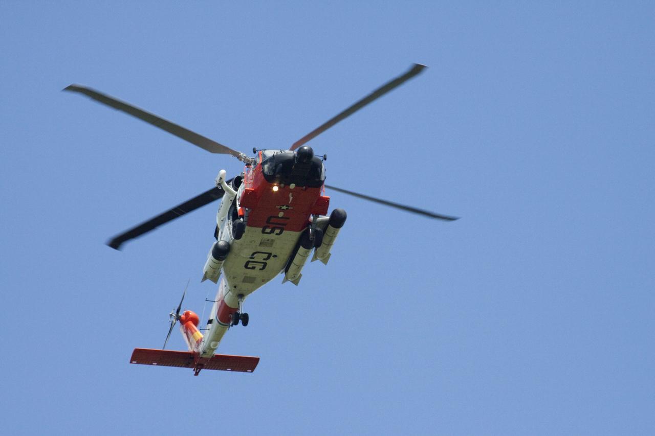 CAPE CANAVERAL, Fla. -- High above the skies at NASA's Kennedy Space Center in Florida a Coast Guard helicopter keeps watch on and around the Atlantic Ocean including space shuttle Atlantis on its seaside launch pad awaiting liftoff on its STS-135 mission.        Atlantis and its crew of four; Commander Chris Ferguson, Pilot Doug Hurley, Mission Specialists Sandy Magnus and Rex Walheim are scheduled to lift off at 11:26 a.m. EDT on July 8 to deliver the Raffaello multi-purpose logistics module packed with supplies and spare parts for the International Space Station. Atlantis also will fly the Robotic Refueling Mission experiment that will investigate the potential for robotically refueling existing satellites in orbit. In addition, Atlantis will return with a failed ammonia pump module to help NASA better understand the failure mechanism and improve pump designs for future systems. STS-135 is the 33rd flight of Atlantis, the 37th shuttle mission to the space station, and the 135th and final mission of NASA's Space Shuttle Program. For more information, visit www.nasa.gov/mission_pages/shuttle/shuttlemissions/sts135/index.html. Photo credit: Ken Thornsley