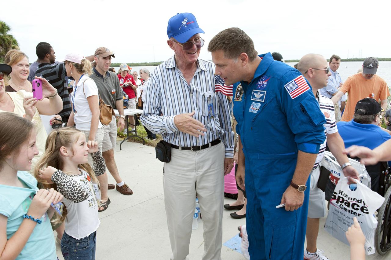 CAPE CANAVERAL, Fla. -- At the Banana River Creek VIP viewing area at NASA's Kennedy Space Center in Florida, NASA astronaut Doug Wheelock speaks with a spectator before the upcoming launch of space shuttle Atlantis' STS-135 mission to the International Space Station.        Atlantis with its crew of four; Commander Chris Ferguson, Pilot Doug Hurley, Mission Specialists Sandy Magnus and Rex Walheim, lifted off at 11:29 a.m. EDT on July 8, 2011 to deliver the Raffaello multi-purpose logistics module packed with supplies and spare parts for the International Space Station. Atlantis also will fly the Robotic Refueling Mission experiment that will investigate the potential for robotically refueling existing satellites in orbit. In addition, Atlantis will return with a failed ammonia pump module to help NASA better understand the failure mechanism and improve pump designs for future systems. STS-135 is the 33rd flight of Atlantis, the 37th shuttle mission to the space station, and the 135th and final mission of NASA's Space Shuttle Program. For more information, visit www.nasa.gov/mission_pages/shuttle/shuttlemissions/sts135/index.html. Photo credit: NASA/Chad Baumer