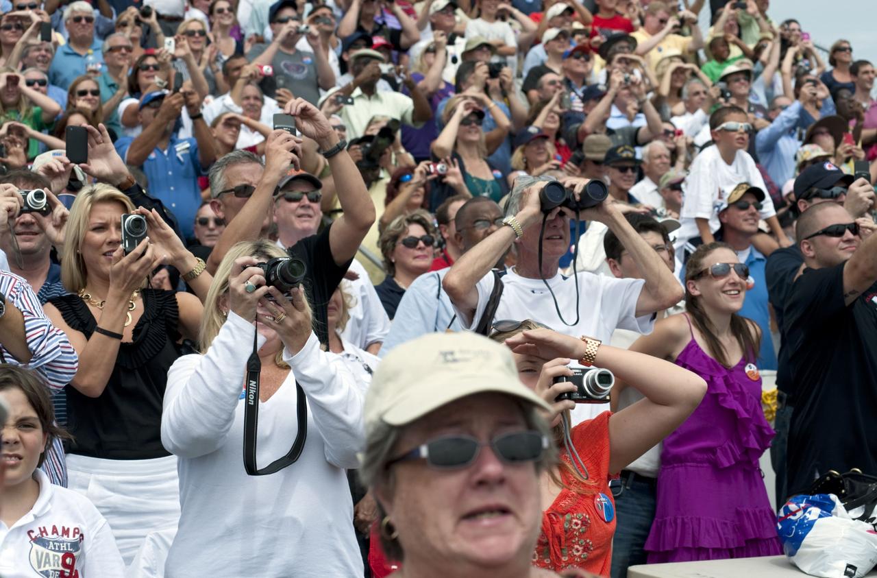 CAPE CANAVERAL, Fla. -- At the Banana River Creek VIP viewing area at NASA's Kennedy Space Center in Florida, spectators have their cameras trained on Launch Pad 39A as space shuttle Atlantis lifts off to begin its STS-135 mission to the International Space Station. Atlantis with its crew of four; Commander Chris Ferguson, Pilot Doug Hurley, Mission Specialists Sandy Magnus and Rex Walheim, lifted off at 11:29 a.m. EDT on July 8, 2011 to deliver the Raffaello multi-purpose logistics module packed with supplies and spare parts for the International Space Station. Atlantis also will fly the Robotic Refueling Mission experiment that will investigate the potential for robotically refueling existing satellites in orbit. In addition, Atlantis will return with a failed ammonia pump module to help NASA better understand the failure mechanism and improve pump designs for future systems. STS-135 is the 33rd flight of Atlantis, the 37th shuttle mission to the space station, and the 135th and final mission of NASA's Space Shuttle Program. For more information, visit www.nasa.gov/mission_pages/shuttle/shuttlemissions/sts135/index.html. Photo credit: NASA/Chad Baumer