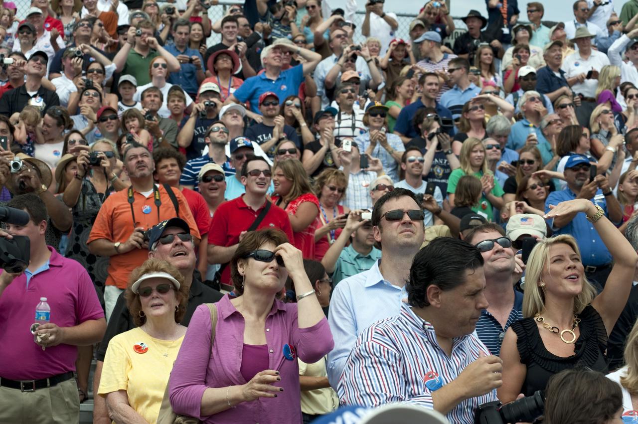 CAPE CANAVERAL, Fla. -- At the Banana River Creek VIP viewing area at NASA's Kennedy Space Center in Florida, spectators follow space shuttle Atlantis as it soars into space on its STS-135 mission to the International Space Station.      Atlantis with its crew of four; Commander Chris Ferguson, Pilot Doug Hurley, Mission Specialists Sandy Magnus and Rex Walheim, lifted off at 11:29 a.m. EDT on July 8, 2011 to deliver the Raffaello multi-purpose logistics module packed with supplies and spare parts for the International Space Station. Atlantis also will fly the Robotic Refueling Mission experiment that will investigate the potential for robotically refueling existing satellites in orbit. In addition, Atlantis will return with a failed ammonia pump module to help NASA better understand the failure mechanism and improve pump designs for future systems. STS-135 is the 33rd flight of Atlantis, the 37th shuttle mission to the space station, and the 135th and final mission of NASA's Space Shuttle Program. For more information, visit www.nasa.gov/mission_pages/shuttle/shuttlemissions/sts135/index.html. Photo credit: NASA/Chad Baumer