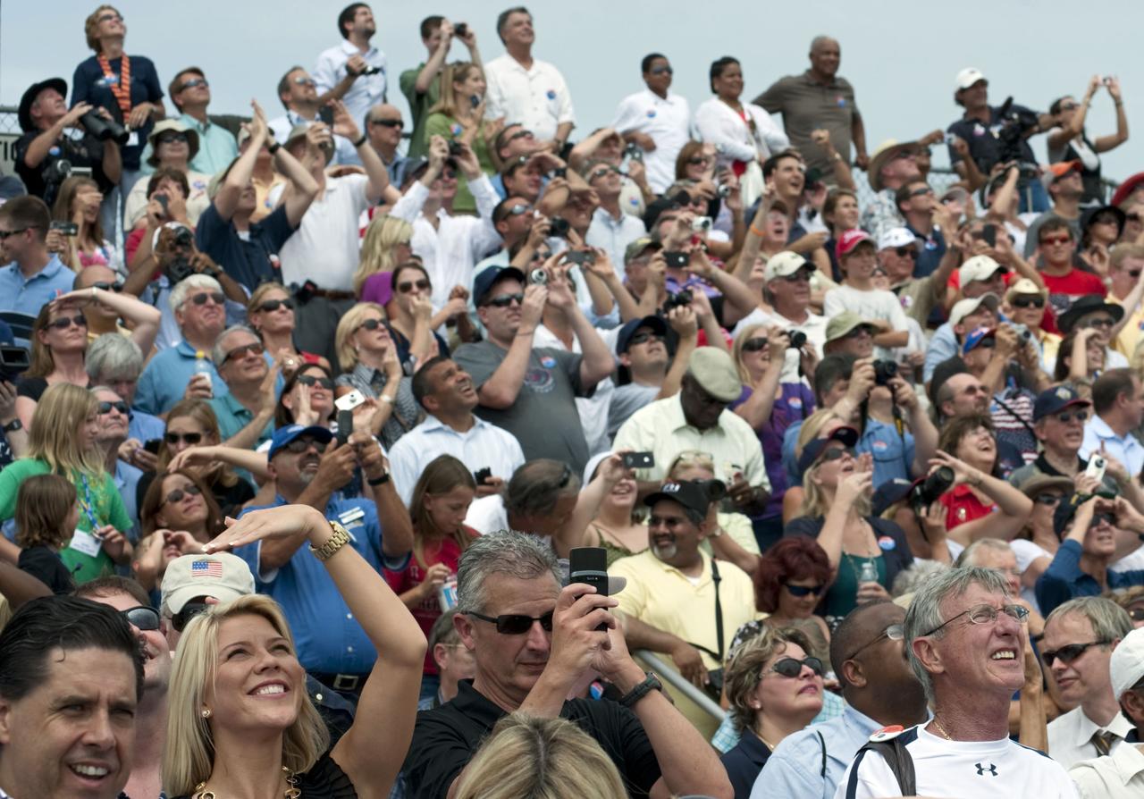 CAPE CANAVERAL, Fla. -- At the Banana River Creek VIP viewing area at NASA's Kennedy Space Center in Florida, spectators smile with delight as they watch space shuttle Atlantis soar into space on its STS-135 mission to the International Space Station. Atlantis with its crew of four; Commander Chris Ferguson, Pilot Doug Hurley, Mission Specialists Sandy Magnus and Rex Walheim, lifted off at 11:29 a.m. EDT on July 8, 2011 to deliver the Raffaello multi-purpose logistics module packed with supplies and spare parts for the International Space Station. Atlantis also will fly the Robotic Refueling Mission experiment that will investigate the potential for robotically refueling existing satellites in orbit. In addition, Atlantis will return with a failed ammonia pump module to help NASA better understand the failure mechanism and improve pump designs for future systems. STS-135 is the 33rd flight of Atlantis, the 37th shuttle mission to the space station, and the 135th and final mission of NASA's Space Shuttle Program. For more information, visit www.nasa.gov/mission_pages/shuttle/shuttlemissions/sts135/index.html. Photo credit: NASA/Chad Baumer