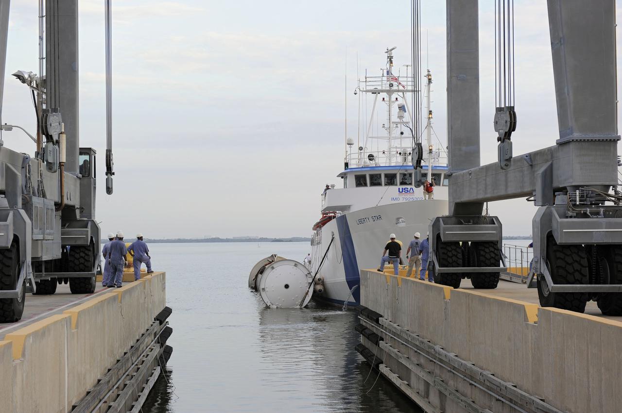 CAPE CANAVERAL, Fla. – Liberty Star, one of NASA’s solid rocket booster retrieval ships, tows a spent booster from space shuttle Atlantis’ final launch, to Port Canaveral in Florida. The shuttle’s two solid rocket booster casings and associated flight hardware are recovered in the Atlantic Ocean after every launch by Freedom Star and Liberty Star. The boosters impact the Atlantic about seven minutes after liftoff, and the retrieval ships are stationed about 10 miles from the impact area at the time of splashdown.    After the spent segments are processed, they will be transported to Utah, where they will be deserviced and stored, if needed. Atlantis began its final flight, STS-135, at 11:29 a.m. EDT on July 8 to deliver the Raffaello multi-purpose logistics module packed with supplies and spare parts to the International Space Station. Photo credit: NASA/Kim Shiflett