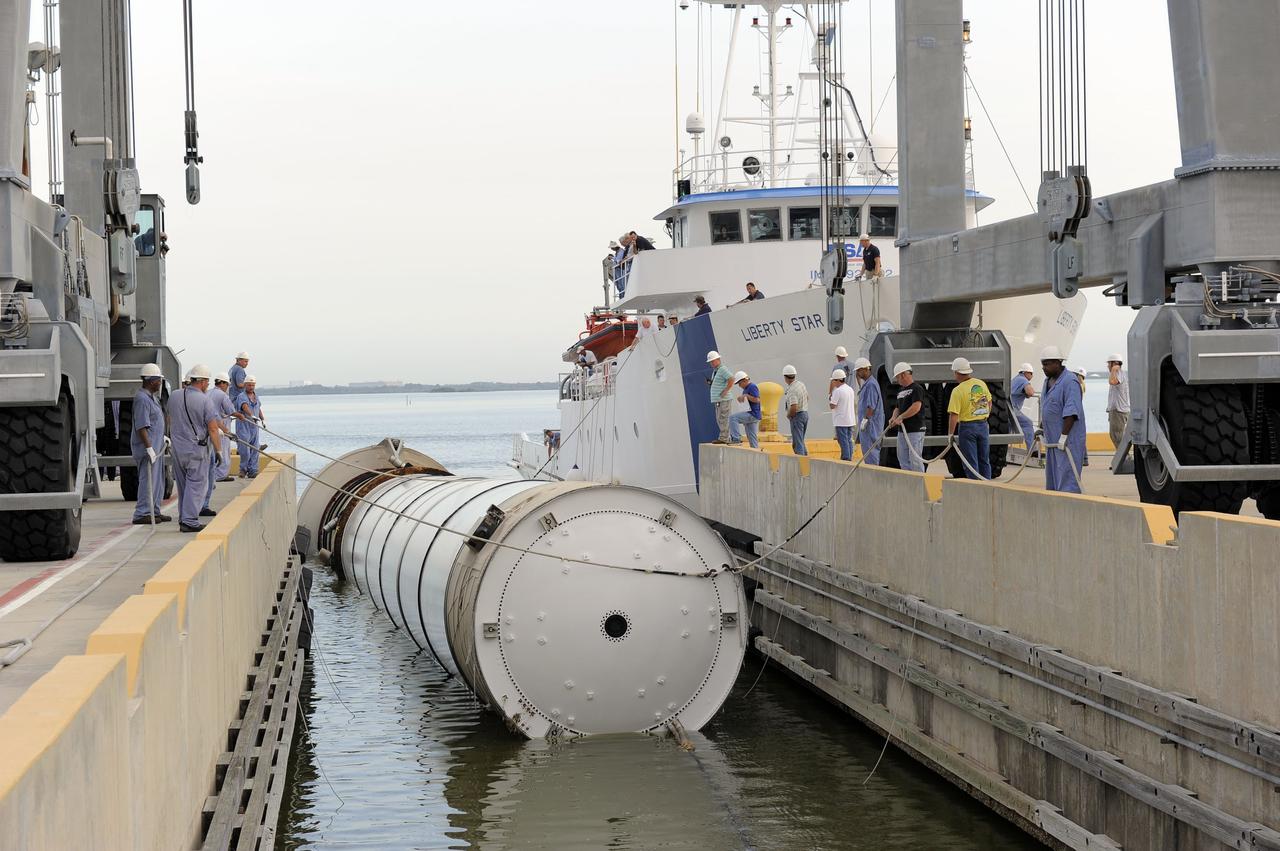 CAPE CANAVERAL, Fla. – Workers assist as Liberty Star, one of NASA’s solid rocket booster retrieval ships, tows a spent booster from space shuttle Atlantis’ final launch to Port Canaveral in Florida. The shuttle’s two solid rocket booster casings and associated flight hardware are recovered in the Atlantic Ocean after every launch by Freedom Star and Liberty Star. The boosters impact the Atlantic about seven minutes after liftoff, and the retrieval ships are stationed about 10 miles from the impact area at the time of splashdown.    After the spent segments are processed, they will be transported to Utah, where they will be deserviced and stored, if needed. Atlantis began its final flight, STS-135, at 11:29 a.m. EDT on July 8 to deliver the Raffaello multi-purpose logistics module packed with supplies and spare parts to the International Space Station. Photo credit: NASA/Kim Shiflett