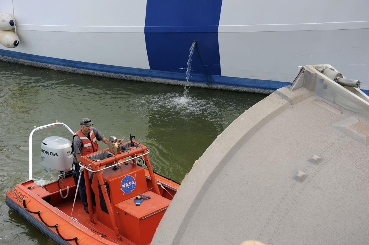CAPE CANAVERAL, Fla. – A United Space Alliance tugboat driver monitors the progress as Liberty Star, one of NASA’s solid rocket booster retrieval ships, tows a spent booster from space shuttle Atlantis’ final launch to Port Canaveral in Florida. The shuttle’s two solid rocket booster casings and associated flight hardware are recovered in the Atlantic Ocean after every launch by Freedom Star and Liberty Star. The boosters impact the Atlantic about seven minutes after liftoff, and the retrieval ships are stationed about 10 miles from the impact area at the time of splashdown.    After the spent segments are processed, they will be transported to Utah, where they will be deserviced and stored, if needed. Atlantis began its final flight, STS-135, at 11:29 a.m. EDT on July 8 to deliver the Raffaello multi-purpose logistics module packed with supplies and spare parts to the International Space Station. Photo credit: NASA/Kim Shiflett