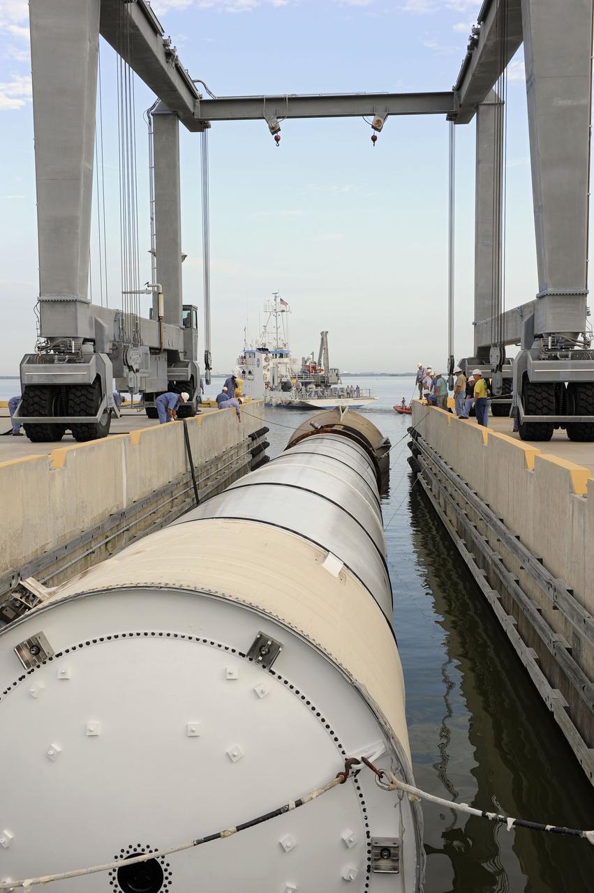 CAPE CANAVERAL, Fla. – One of two solid rocket boosters is secured to a mooring at Port Canaveral in Florida. Liberty Star, one of NASA’s two booster retrieval ships, towed the spent booster from space shuttle Atlantis’ final launch to the port. The shuttle’s two solid rocket booster casings and associated flight hardware are recovered in the Atlantic Ocean after every launch by Freedom Star and Liberty Star. The boosters impact the Atlantic about seven minutes after liftoff, and the retrieval ships are stationed about 10 miles from the impact area at the time of splashdown.      After the spent segments are processed, they will be transported to Utah, where they will be deserviced and stored, if needed. Atlantis began its final flight, STS-135, at 11:29 a.m. EDT on July 8 to deliver the Raffaello multi-purpose logistics module packed with supplies and spare parts to the International Space Station. Photo credit: NASA/Kim Shiflett