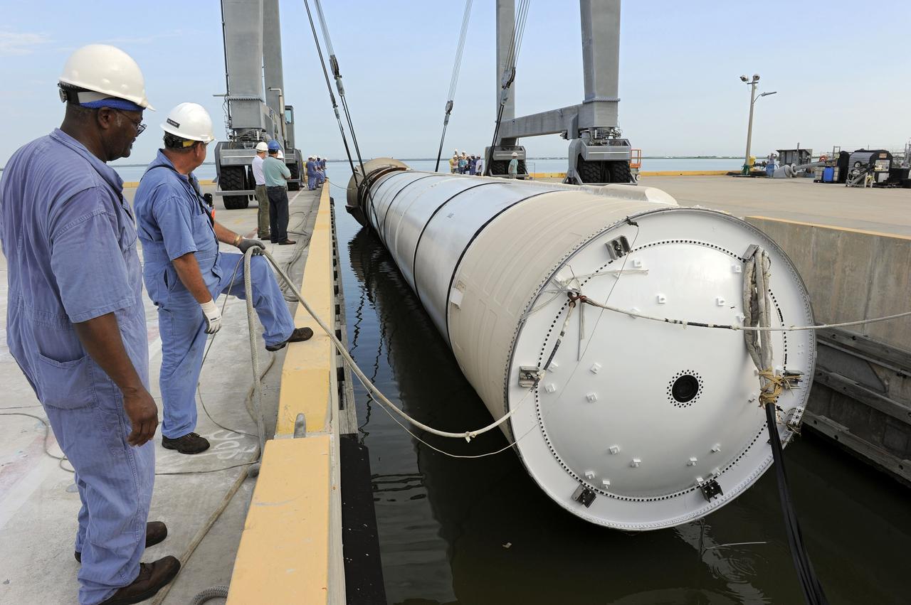 CAPE CANAVERAL, Fla. – Workers help secure one of two solid rocket boosters to a mooring at Port Canaveral in Florida.  Liberty Star, one of NASA’s two booster retrieval ships, towed the spent booster from space shuttle Atlantis’ final launch to the port. The shuttle’s two solid rocket booster casings and associated flight hardware are recovered in the Atlantic Ocean after every launch by Freedom Star and Liberty Star. The boosters impact the Atlantic about seven minutes after liftoff, and the retrieval ships are stationed about 10 miles from the impact area at the time of splashdown.    After the spent segments are processed, they will be transported to Utah, where they will be deserviced and stored, if needed. Atlantis began its final flight, STS-135, at 11:29 a.m. EDT on July 8 to deliver the Raffaello multi-purpose logistics module packed with supplies and spare parts to the International Space Station. Photo credit: NASA/Kim Shiflett