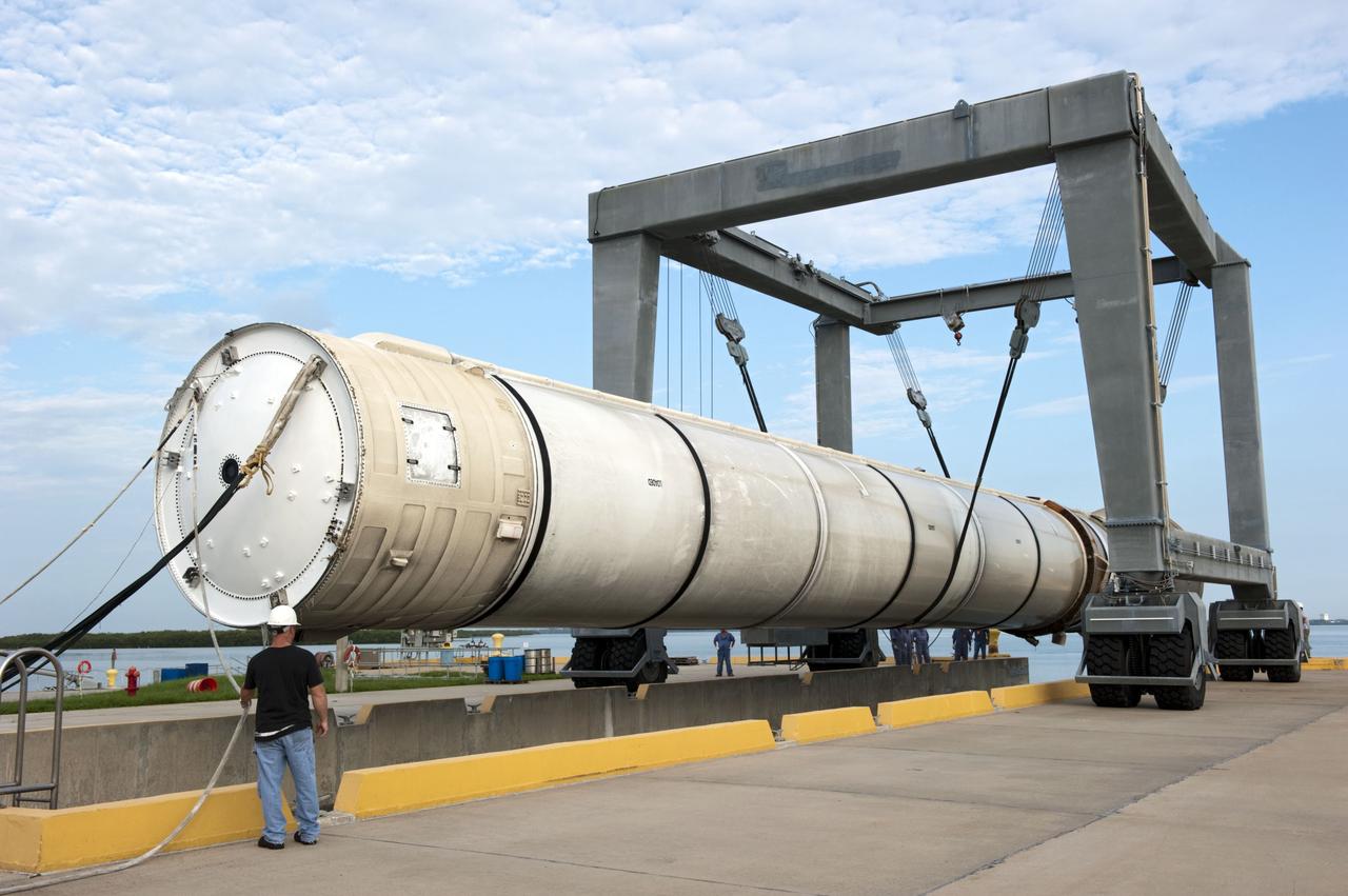 CAPE CANAVERAL, Fla. – One of two solid rocket boosters is lifted above a mooring at Port Canaveral in Florida.  Liberty Star, one of NASA’s two booster retrieval ships, towed the spent booster from space shuttle Atlantis’ final launch to the port. The shuttle’s two solid rocket booster casings and associated flight hardware are recovered in the Atlantic Ocean after every launch by Freedom Star and Liberty Star. The boosters impact the Atlantic about seven minutes after liftoff, and the retrieval ships are stationed about 10 miles from the impact area at the time of splashdown.    After the spent segments are processed, they will be transported to Utah, where they will be deserviced and stored, if needed. Atlantis began its final flight, STS-135, at 11:29 a.m. EDT on July 8 to deliver the Raffaello multi-purpose logistics module packed with supplies and spare parts to the International Space Station. Photo credit: NASA/Kim Shiflett