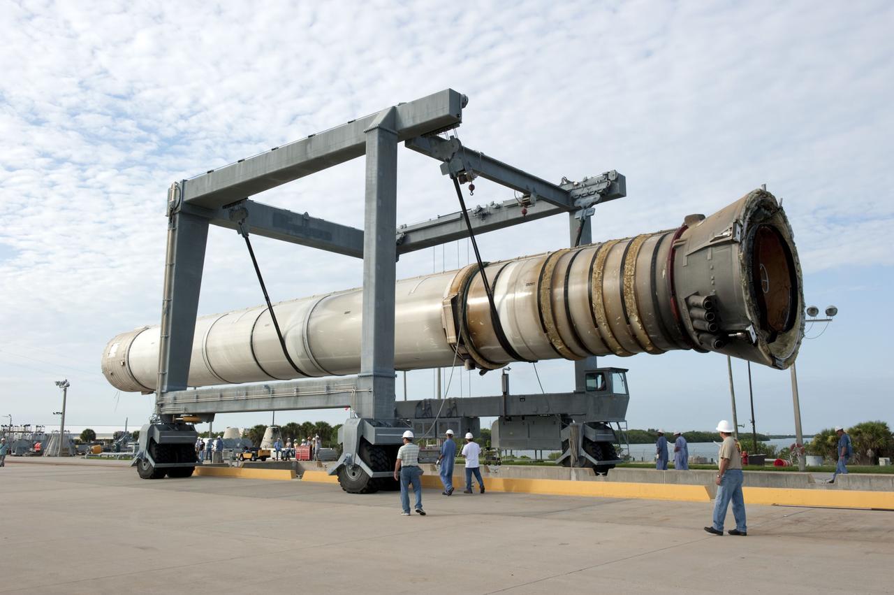 CAPE CANAVERAL, Fla. -- One of two solid rocket boosters is transported from a mooring at Port Canaveral in Florida to Hangar AF at Cape Canaveral Air Force Station. Liberty Star, one of NASA’s two booster retrieval ships, towed the spent booster from space shuttle Atlantis’ final launch to the port. The shuttle’s two solid rocket booster casings and associated flight hardware are recovered in the Atlantic Ocean after every launch by Freedom Star and Liberty Star. The boosters impact the Atlantic about seven minutes after liftoff, and the retrieval ships are stationed about 10 miles from the impact area at the time of splashdown.    After the spent segments are processed, they will be transported to Utah, where they will be deserviced and stored, if needed. Atlantis began its final flight, STS-135, at 11:29 a.m. EDT on July 8 to deliver the Raffaello multi-purpose logistics module packed with supplies and spare parts to the International Space Station. Photo credit: NASA/Kim Shiflett