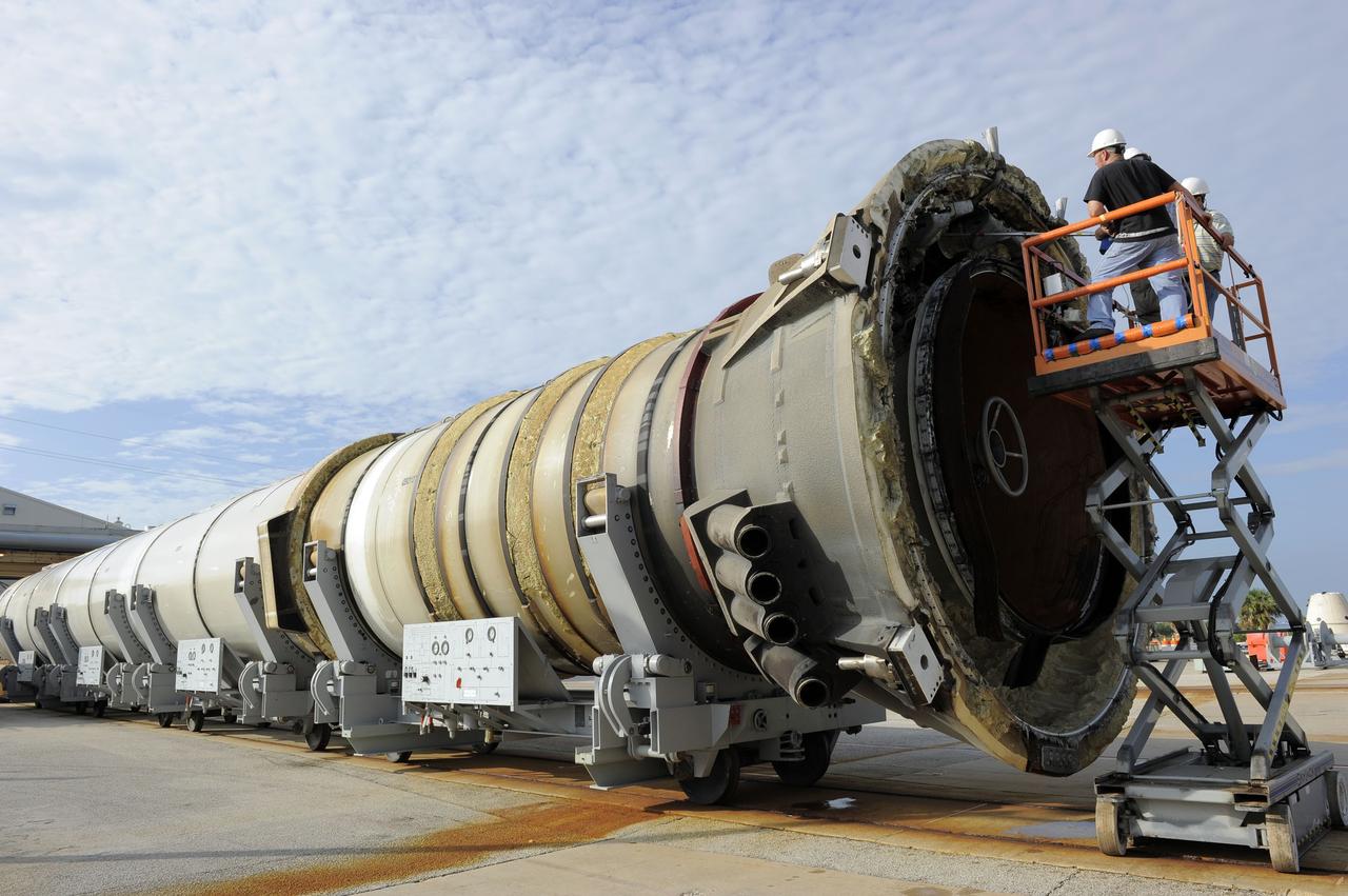 CAPE CANAVERAL, Fla. – Workers prepare one of two solid rocket boosters for deservicing at Hangar AF at Cape Canaveral Air Force Station in Florida. Liberty Star, one of NASA’s two booster retrieval ships, towed the spent booster from space shuttle Atlantis’ final launch to a mooring at Port Canaveral. The shuttle’s two solid rocket booster casings and associated flight hardware are recovered in the Atlantic Ocean after every launch by Freedom Star and Liberty Star. The boosters impact the Atlantic about seven minutes after liftoff, and the retrieval ships are stationed about 10 miles from the impact area at the time of splashdown.      After the spent segments are processed, they will be transported to Utah, where they will be deserviced and stored, if needed. Atlantis began its final flight, STS-135, at 11:29 a.m. EDT on July 8 to deliver the Raffaello multi-purpose logistics module packed with supplies and spare parts to the International Space Station. Photo credit: NASA/Kim Shiflett