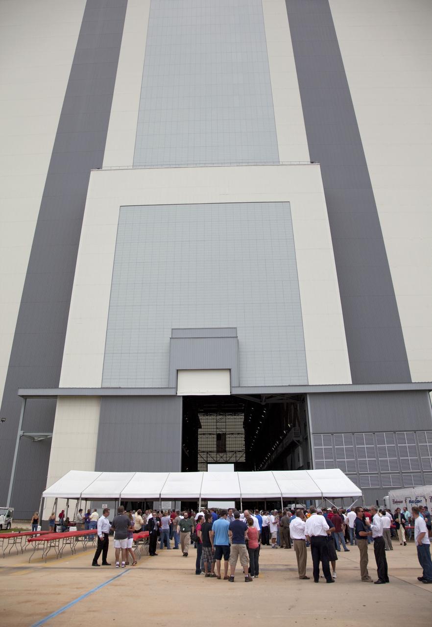 CAPE CANAVERAL, Fla. -- After the successful liftoff of space shuttle Atlantis on the STS-135 mission, hundreds of shuttle workers gather for a party at a tent beside the looming, 525-foot-tall Vehicle Assembly Building at NASA's Kennedy Space Center in Florida. STS-135 is the final flight of the agency's Space Shuttle Program. Atlantis, with its crew of Commander Chris Ferguson, Pilot Doug Hurley, Mission Specialists Sandy Magnus and Rex Walheim, lifted off at 11:29 a.m. EDT on July 8, 2011 to deliver the Raffaello multi-purpose logistics module packed with supplies and spare parts for the International Space Station. For more information, visit www.nasa.gov/mission_pages/shuttle/shuttlemissions/sts135/index.html. Photo credit: NASA/Frankie Martin