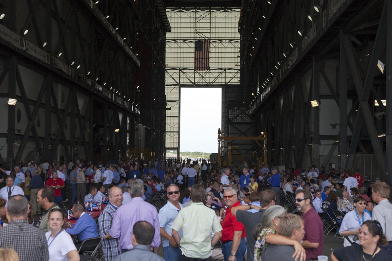 CAPE CANAVERAL, Fla. -- Space shuttle workers fill the transfer aisle of the massive Vehicle Assembly Building at NASA's Kennedy Space Center in Florida to celebrate the successful liftoff of shuttle Atlantis on the STS-135 mission, the final flight of the agency's Space Shuttle Program. Atlantis, with its crew of Commander Chris Ferguson, Pilot Doug Hurley, Mission Specialists Sandy Magnus and Rex Walheim, lifted off at 11:29 a.m. EDT on July 8, 2011 to deliver the Raffaello multi-purpose logistics module packed with supplies and spare parts for the International Space Station. For more information, visit www.nasa.gov/mission_pages/shuttle/shuttlemissions/sts135/index.html. Photo credit: NASA/Frankie Martin