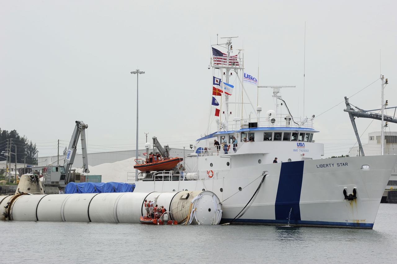 CAPE CANAVERAL, Fla. -- Liberty Star, one of NASA's solid rocket booster retrieval ships, maneuvers the right spent booster from space shuttle Atlantis' final launch, as it is taken to Port Canaveral in Florida. The shuttle's two solid rocket booster casings and associated flight hardware are recovered in the Atlantic Ocean after every launch by Freedom Star and Liberty Star. The boosters impact the Atlantic about seven minutes after liftoff and the retrieval ships are stationed about 10 miles from the impact area at the time of splashdown. After the spent segments are processed, they will be transported to Utah, where they will be deserviced and stored, if needed. Atlantis began its final flight at 11:29 a.m. EDT on July 8 to deliver the Raffaello multi-purpose logistics module packed with supplies and spare parts for the International Space Station. Atlantis also delivers the Robotic Refueling Mission experiment that will investigate the potential for robotically refueling existing satellites in orbit to the station. In addition, Atlantis will return with a failed ammonia pump module to help NASA better understand the failure mechanism and improve pump designs for future systems. STS-135 is the 33rd flight of Atlantis, the 37th shuttle mission to the space station, and the 135th and final mission of NASA's Space Shuttle Program. For more information, visit www.nasa.gov/mission_pages/shuttle/shuttlemissions/sts135/index.html. Photo credit: NASA/Kim Shiflett