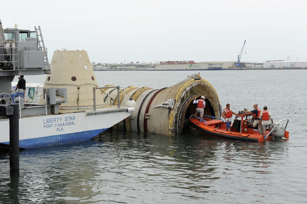 CAPE CANAVERAL, Fla. – Crews from the Liberty Star, one of NASA's solid rocket booster retrieval ships, inspect the end of the right spent booster from space shuttle Atlantis' final launch, as it is taken to a berth at Port Canaveral in Florida. The shuttle's two solid rocket booster casings and associated flight hardware are recovered in the Atlantic Ocean after every launch by Freedom Star and Liberty Star. The boosters impact the Atlantic about seven minutes after liftoff and the retrieval ships are stationed about 10 miles from the impact area at the time of splashdown. After the spent segments are processed, they will be transported to Utah, where they will be deserviced and stored, if needed. Atlantis began its final flight at 11:29 a.m. EDT on July 8 to deliver the Raffaello multi-purpose logistics module packed with supplies and spare parts for the International Space Station. Atlantis also delivers the Robotic Refueling Mission experiment that will investigate the potential for robotically refueling existing satellites in orbit to the station. In addition, Atlantis will return with a failed ammonia pump module to help NASA better understand the failure mechanism and improve pump designs for future systems. STS-135 is the 33rd flight of Atlantis, the 37th shuttle mission to the space station, and the 135th and final mission of NASA's Space Shuttle Program. For more information, visit www.nasa.gov/mission_pages/shuttle/shuttlemissions/sts135/index.html. Photo credit: NASA/Kim Shiflett