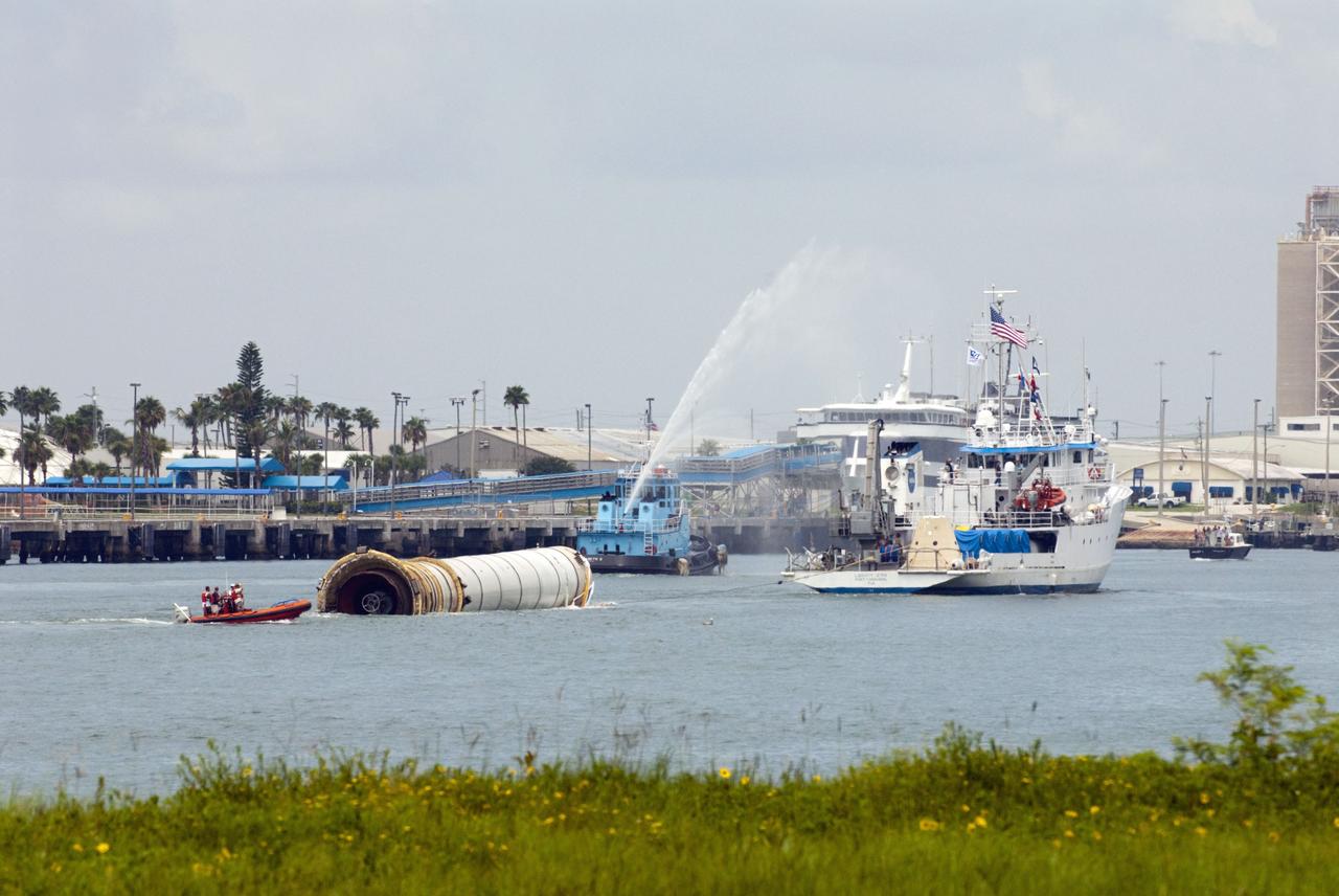 CAPE CANAVERAL, Fla. – A water-spraying tugboat escorts the Liberty Star as it tows the right spent booster from space shuttle Atlantis' final to Port Canaveral in Florida. The Liberty Star is one of NASA's solid rocket booster retrieval ships. The shuttle's two solid rocket booster casings and associated flight hardware are recovered in the Atlantic Ocean after every launch by Freedom Star and Liberty Star. The boosters impact the Atlantic about seven minutes after liftoff and the retrieval ships are stationed about 10 miles from the impact area at the time of splashdown. After the spent segments are processed, they will be transported to Utah, where they will be deserviced and stored, if needed. Atlantis began its final flight at 11:29 a.m. EDT on July 8 to deliver the Raffaello multi-purpose logistics module packed with supplies and spare parts for the International Space Station. Atlantis also delivers the Robotic Refueling Mission experiment that will investigate the potential for robotically refueling existing satellites in orbit to the station. In addition, Atlantis will return with a failed ammonia pump module to help NASA better understand the failure mechanism and improve pump designs for future systems. STS-135 is the 33rd flight of Atlantis, the 37th shuttle mission to the space station, and the 135th and final mission of NASA's Space Shuttle Program. For more information, visit www.nasa.gov/mission_pages/shuttle/shuttlemissions/sts135/index.html. Photo credit: NASA/Kim Shiflett
