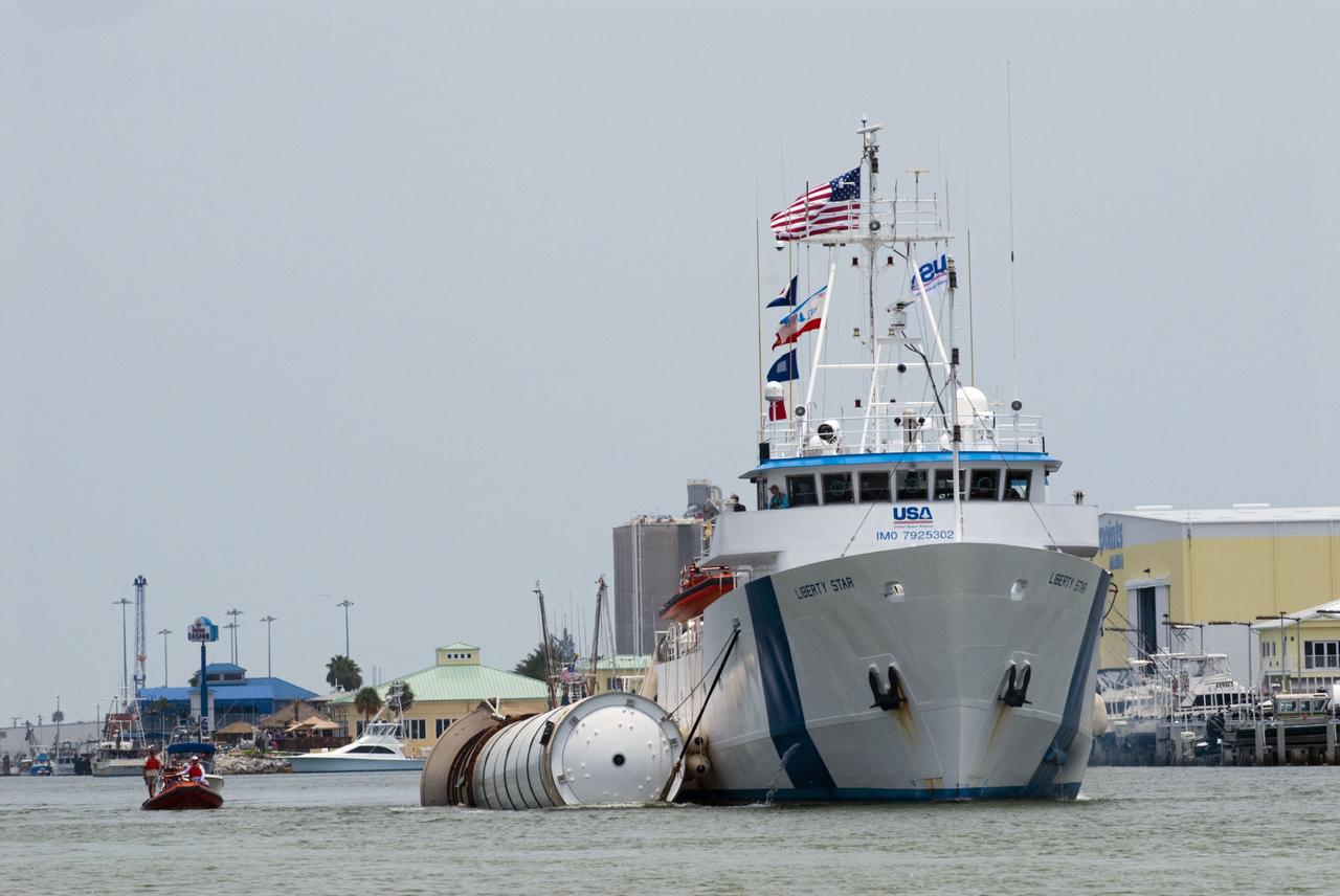 CAPE CANAVERAL, Fla. -- Liberty Star, one of NASA's solid rocket booster retrieval ships, tows the right spent booster from space shuttle Atlantis' final launch, as it is taken to Port Canaveral in Florida. The shuttle's two solid rocket booster casings and associated flight hardware are recovered in the Atlantic Ocean after every launch by Freedom Star and Liberty Star. The boosters impact the Atlantic about seven minutes after liftoff and the retrieval ships are stationed about 10 miles from the impact area at the time of splashdown. After the spent segments are processed, they will be transported to Utah, where they will be deserviced and stored, if needed. Atlantis began its final flight at 11:29 a.m. EDT on July 8 to deliver the Raffaello multi-purpose logistics module packed with supplies and spare parts for the International Space Station. Atlantis also delivers the Robotic Refueling Mission experiment that will investigate the potential for robotically refueling existing satellites in orbit to the station. In addition, Atlantis will return with a failed ammonia pump module to help NASA better understand the failure mechanism and improve pump designs for future systems. STS-135 is the 33rd flight of Atlantis, the 37th shuttle mission to the space station, and the 135th and final mission of NASA's Space Shuttle Program. For more information, visit www.nasa.gov/mission_pages/shuttle/shuttlemissions/sts135/index.html. Photo credit: NASA/Kim Shiflett