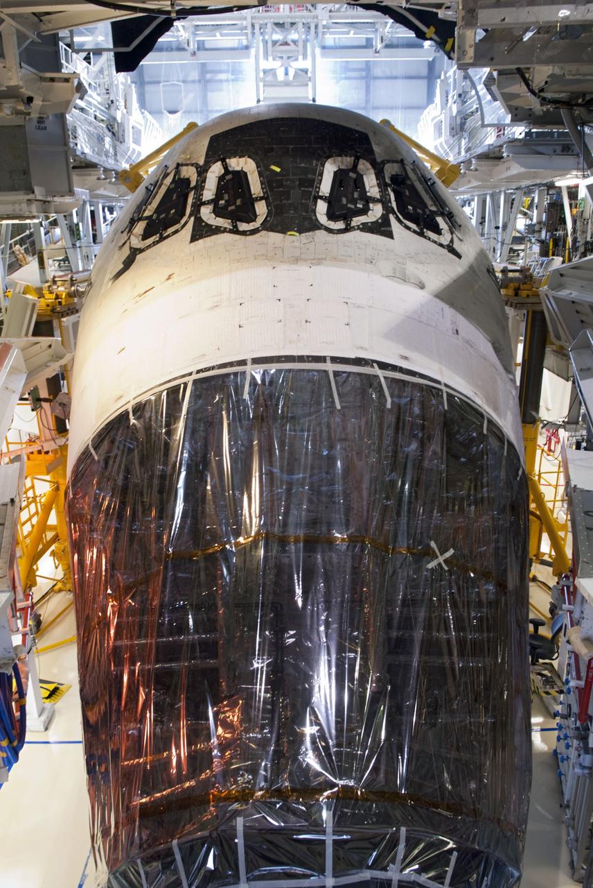 CAPE CANAVERAL, Fla. -- In Orbiter Processing Facility-2, or OPF-2, at NASA's Kennedy Space Center in Florida, protective plastic covers the nose of space shuttle Discovery where its forward reaction control system (FRCS) once resided. Discovery's FRCS was removed and shipped to White Sands Space Harbor in New Mexico for a full cleaning and deservicing before it is returned to Kennedy and reinstalled. Discovery is being prepared for its move to the Vehicle Assembly Building, or VAB. Discovery will be stored inside the VAB for approximately one month while shuttle Atlantis undergoes processing in OPF-2 following its final mission, STS-135. Discovery flew its 39th and final mission, STS-133, in February and March 2011, and currently is being prepared for public display at the Smithsonian's National Air and Space Museum Steven F. Udvar-Hazy Center in Virginia. For more information about Discovery's Transition and Retirement, visit www.nasa.gov/mission_pages/shuttle/launch/discovery_rss_collection_archive_1.html. Photo credit: NASA/Jim Grossmann
