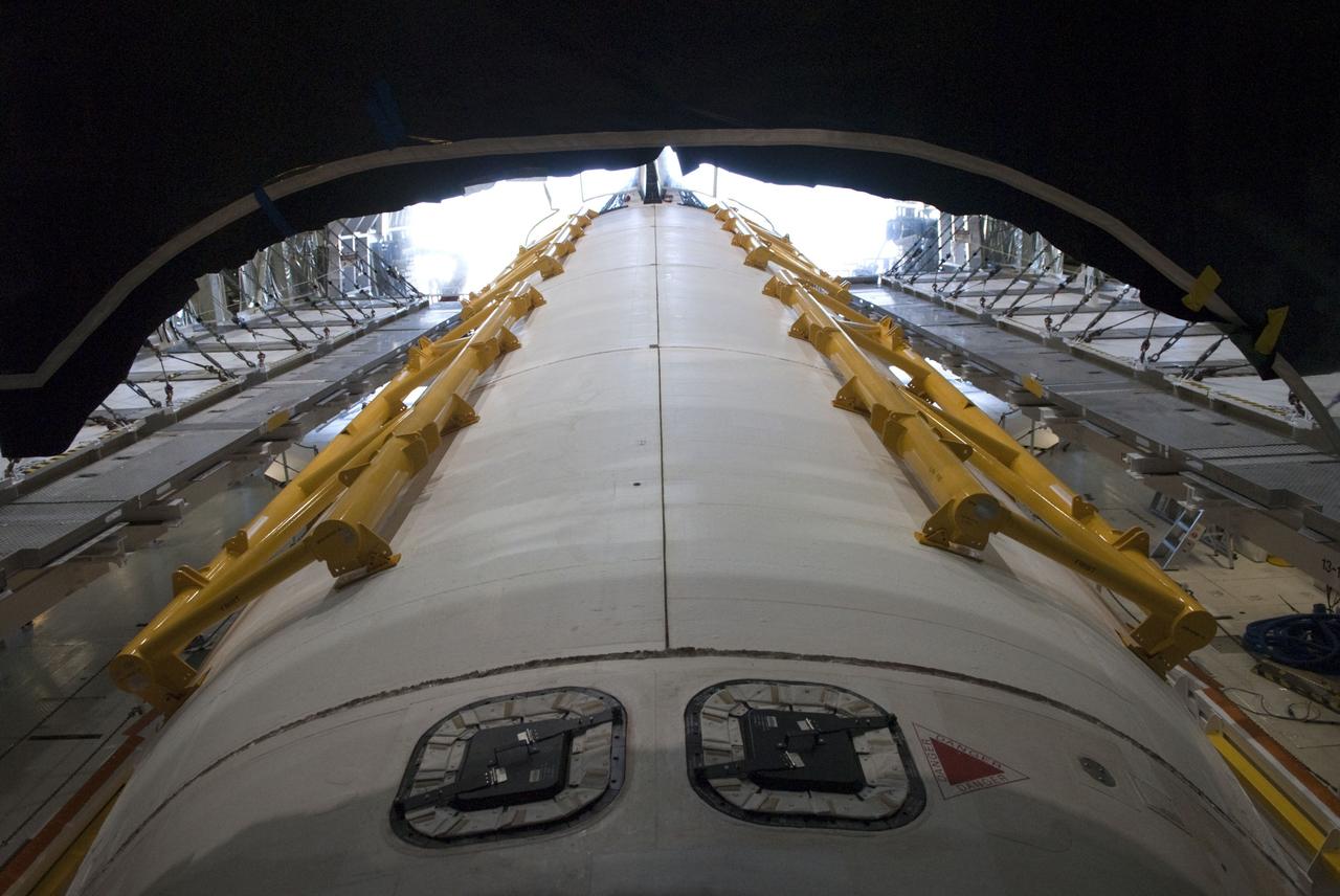 CAPE CANAVERAL, Fla. -- In Orbiter Processing Facility-2, or OPF-2, at NASA's Kennedy Space Center in Florida, railings, called strongbacks, are installed along the payload bay doors of space shuttle Discovery. The strongbacks are used to assist with opening and closing of the doors when the shuttle's hydraulic system is not operational and support the doors while they are open. Discovery is awaiting its move to the Vehicle Assembly Building, or VAB. Discovery will be stored inside the VAB for approximately one month while shuttle Atlantis undergoes processing in OPF-2 following its final mission, STS-135. Discovery flew its 39th and final mission, STS-133, in February and March 2011, and currently is being prepared for public display at the Smithsonian's National Air and Space Museum Steven F. Udvar-Hazy Center in Virginia. For more information about Discovery's Transition and Retirement, visit www.nasa.gov/mission_pages/shuttle/launch/discovery_rss_collection_archive_1.html. Photo credit: NASA/Jim Grossmann