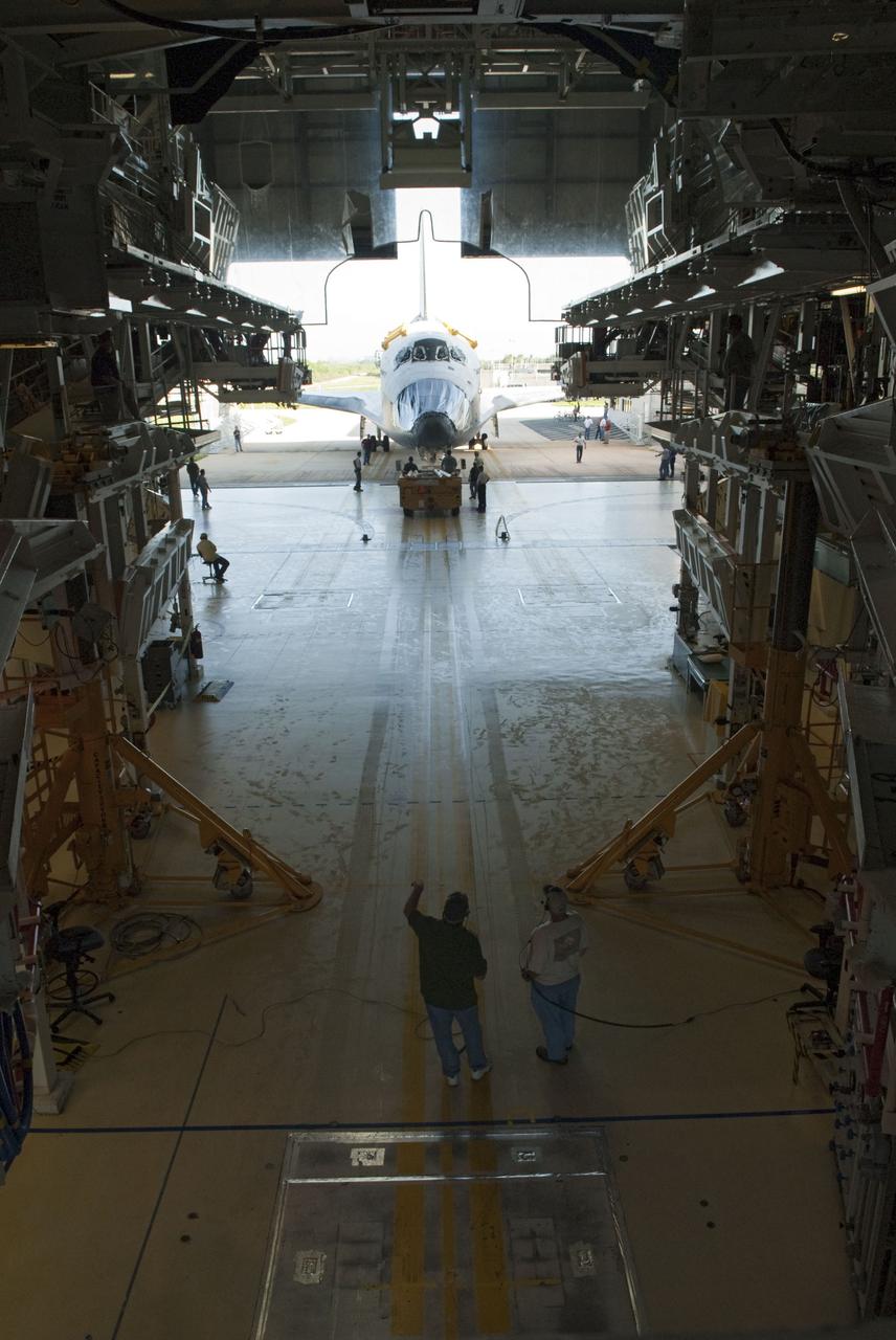 CAPE CANAVERAL, Fla. -- In Orbiter Processing Facility-2, or OPF-2, at NASA's Kennedy Space Center in Florida, space shuttle Discovery is pushed from the processing bay to begin the move to the Vehicle Assembly Building, or VAB. Discovery will be stored inside the VAB for approximately one month while shuttle Atlantis undergoes processing in OPF-2 following its final mission, STS-135. Discovery flew its 39th and final mission, STS-133, in February and March 2011, and currently is being prepared for public display at the Smithsonian's National Air and Space Museum Steven F. Udvar-Hazy Center in Virginia. For more information about Discovery's Transition and Retirement, visit www.nasa.gov/mission_pages/shuttle/launch/discovery_rss_collection_archive_1.html. Photo credit: NASA/Jim Grossmann