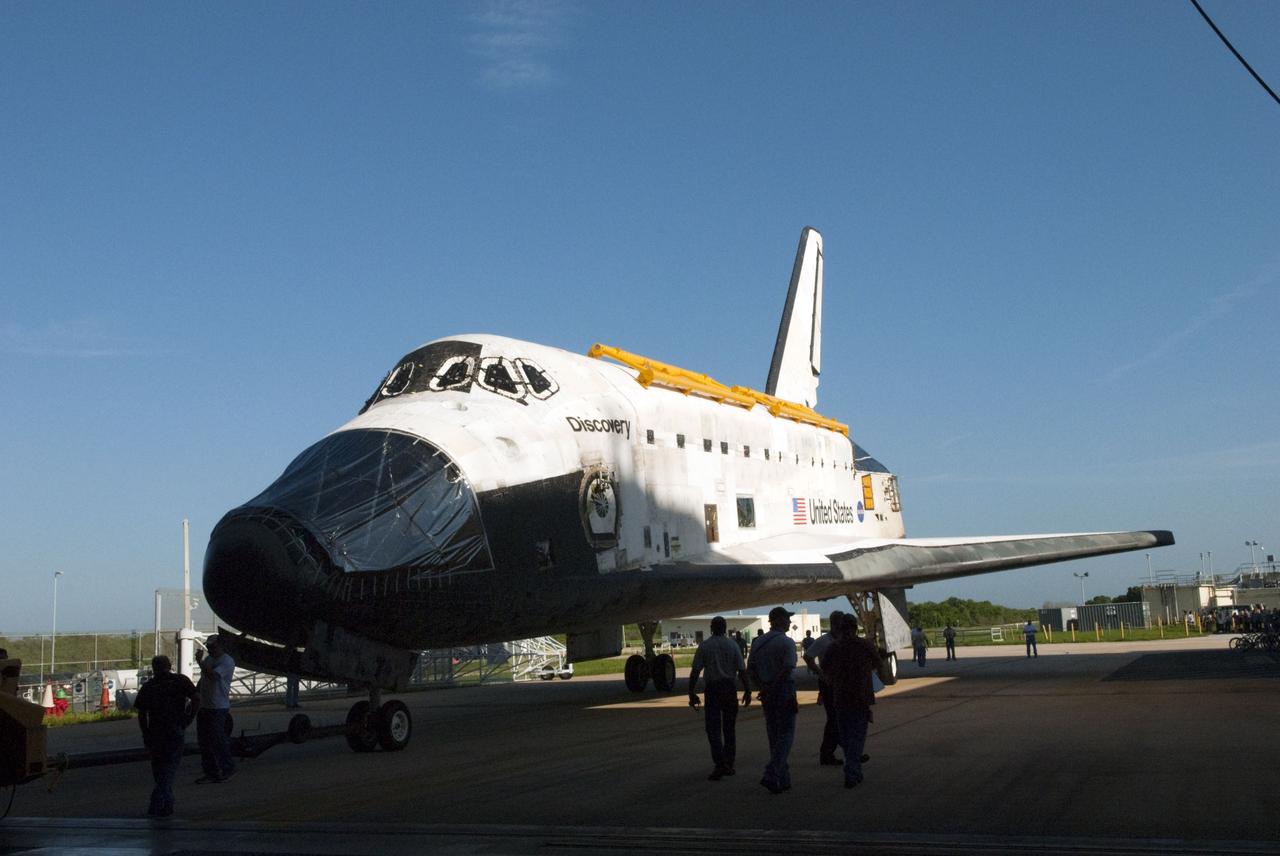 CAPE CANAVERAL, Fla. -- At NASA's Kennedy Space Center in Florida, space shuttle Discovery, as it is seldom seen in public -- its nose encased in protective plastic, its cockpit windows covered, and strongbacks attached to its payload bay doors -- rolls out of Orbiter Processing Facility-2, or OPF-2, on its way to the Vehicle Assembly Building, or VAB. Discovery will be stored inside the VAB for approximately one month while shuttle Atlantis undergoes processing in OPF-2 following its final mission, STS-135. Discovery flew its 39th and final mission, STS-133, in February and March 2011, and currently is being prepared for public display at the Smithsonian's National Air and Space Museum Steven F. Udvar-Hazy Center in Virginia. For more information about Discovery's Transition and Retirement, visit www.nasa.gov/mission_pages/shuttle/launch/discovery_rss_collection_archive_1.html. Photo credit: NASA/Jim Grossmann