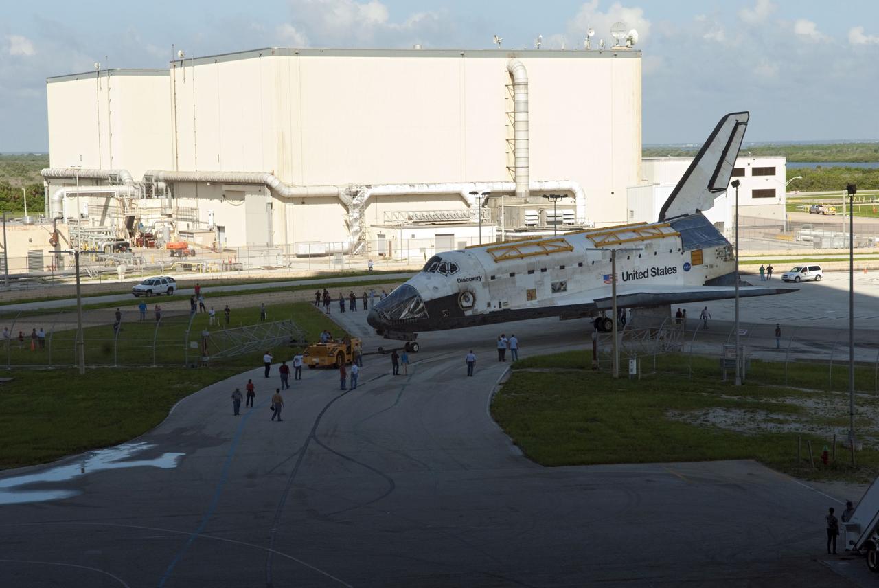 CAPE CANAVERAL, Fla. -- At NASA's Kennedy Space Center in Florida, space shuttle Discovery winds its way from Orbiter Processing Facility-2, or OPF-2, in the background, to the Vehicle Assembly Building, or VAB. Discovery will be stored inside the VAB for approximately one month while shuttle Atlantis undergoes processing in OPF-2 following its final mission, STS-135. Discovery flew its 39th and final mission, STS-133, in February and March 2011, and currently is being prepared for public display at the Smithsonian's National Air and Space Museum Steven F. Udvar-Hazy Center in Virginia. For more information about Discovery's Transition and Retirement, visit www.nasa.gov/mission_pages/shuttle/launch/discovery_rss_collection_archive_1.html. Photo credit: NASA/Jim Grossmann