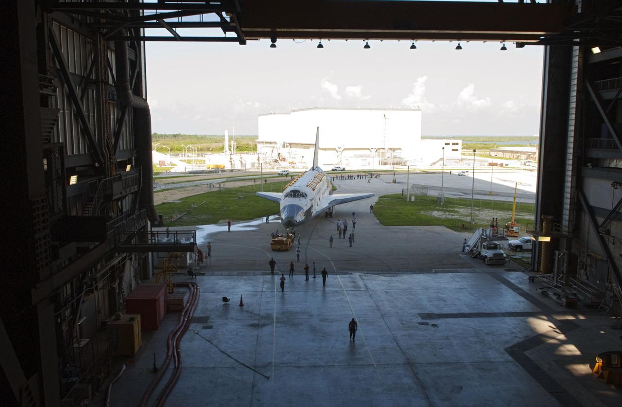 CAPE CANAVERAL, Fla. -- At NASA's Kennedy Space Center in Florida, space shuttle Discovery -- its nose encased in protective plastic, its cockpit windows covered, and strongbacks attached to its payload bay doors -- has arrived at the door of the Vehicle Assembly Building, or VAB, from Orbiter Processing Facility-2, or OPF-2, in the background. Discovery will be stored inside the VAB for approximately one month while shuttle Atlantis undergoes processing in OPF-2 following its final mission, STS-135. Discovery flew its 39th and final mission, STS-133, in February and March 2011, and currently is being prepared for public display at the Smithsonian's National Air and Space Museum Steven F. Udvar-Hazy Center in Virginia. For more information about Discovery's Transition and Retirement, visit www.nasa.gov/mission_pages/shuttle/launch/discovery_rss_collection_archive_1.html. Photo credit: NASA/Jim Grossmann
