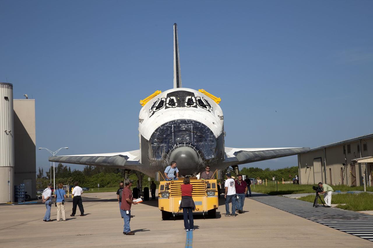 CAPE CANAVERAL, Fla. -- At NASA's Kennedy Space Center in Florida, space shuttle Discovery -- its nose encased in protective plastic, its cockpit windows covered, and strongbacks attached to its payload bay doors -- rolls past the Thermal Protection System Facility, at right, on its way from Orbiter Processing Facility-2, or OPF-2, to the Vehicle Assembly Building, or VAB. Discovery will be stored inside the VAB for approximately one month while shuttle Atlantis undergoes processing in OPF-2 following its final mission, STS-135. Discovery flew its 39th and final mission, STS-133, in February and March 2011, and currently is being prepared for public display at the Smithsonian's National Air and Space Museum Steven F. Udvar-Hazy Center in Virginia. For more information about Discovery's Transition and Retirement, visit www.nasa.gov/mission_pages/shuttle/launch/discovery_rss_collection_archive_1.html. Photo credit: NASA/Frankie Martin