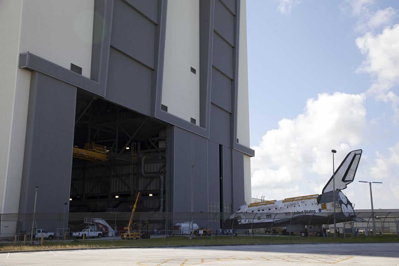 CAPE CANAVERAL, Fla. -- At NASA's Kennedy Space Center in Florida, space shuttle Discovery -- its nose encased in protective plastic, its cockpit windows covered, and strongbacks attached to its payload bay doors -- awaits entry into the Vehicle Assembly Building, or VAB, after rolling from Orbiter Processing Facility-2, or OPF-2. Discovery will be stored inside the VAB for approximately one month while shuttle Atlantis undergoes processing in OPF-2 following its final mission, STS-135. Discovery flew its 39th and final mission, STS-133, in February and March 2011, and currently is being prepared for public display at the Smithsonian's National Air and Space Museum Steven F. Udvar-Hazy Center in Virginia. For more information about Discovery's Transition and Retirement, visit www.nasa.gov/mission_pages/shuttle/launch/discovery_rss_collection_archive_1.html. Photo credit: NASA/Frankie Martin