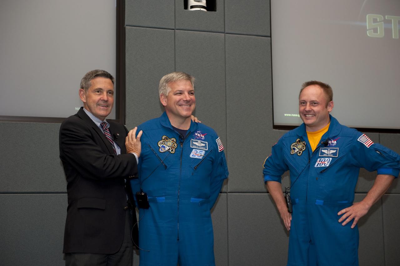 CAPE CANAVERAL, Fla. - Bob Cabana, director of NASA's Kennedy Space Center in Florida, introduces STS-134 Pilot Gregory H. Johnson and Mission Specialist Michael Fincke during a crew return event for employees.     Commander Mark Kelly, Johnson and Mission Specialists Fincke, Greg Chamitoff, Andrew Feustel and European Space Agency astronaut Roberto Vittori lifted off May 16, 2011, aboard space shuttle Endeavour. During the nearly 16-day STS-134 mission, Endeavour delivered to the International Space Station the Alpha Magnetic Spectrometer (AMS) and spare parts, including two S-band communications antennas, a high-pressure gas tank and additional spare parts for Dextre. This was the 36th shuttle mission to the station and Endeavour's 25th and final flight.  For more information, visit www.nasa.gov/mission_pages/shuttle/shuttlemissions/sts134/main/index.html.  Photo credit: NASA/Kim Shiflett