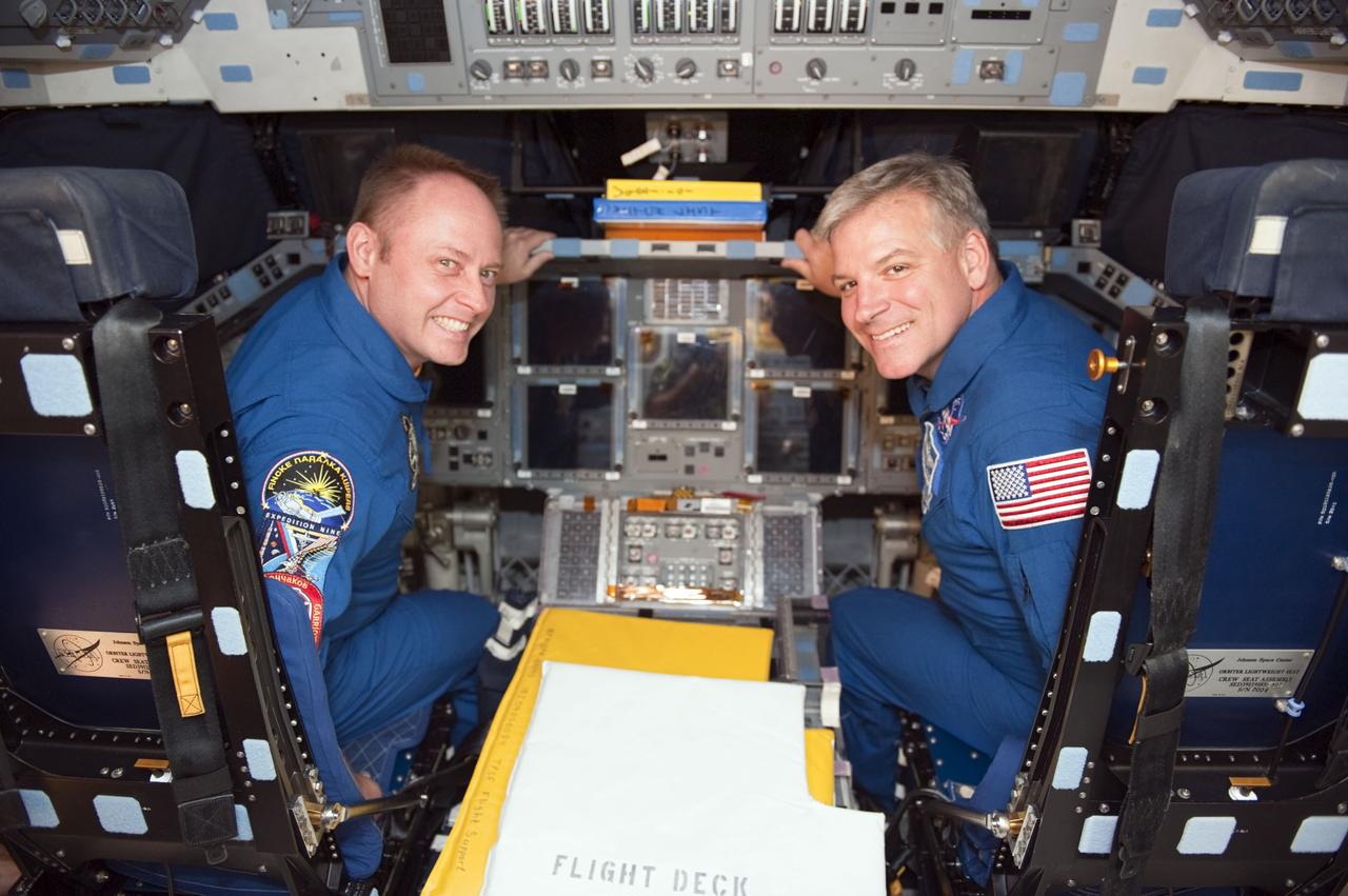 CAPE CANAVERAL, Fla. - STS-134 Mission Specialist Michael Fincke sits in the commander's seat on space shuttle Endeavour's flight deck. He is joined by STS-134 Pilot Gregory H. Johnson, settled in the pilot's seat. The astronauts visited with employees and got an up-close look at Endeavour inside NASA Kennedy Space Center's Orbiter Processing Facility-1, where the spacecraft is being prepared for public display. Commander Mark Kelly, Johnson and Mission Specialists Fincke, Greg Chamitoff, Andrew Feustel and European Space Agency astronaut Roberto Vittori lifted off May 16, 2011 aboard space shuttle Endeavour. During the nearly 16-day STS-134 mission, Endeavour delivered to the International Space Station the Alpha Magnetic Spectrometer (AMS) and spare parts, including two S-band communications antennas, a high-pressure gas tank and additional spare parts for Dextre. This was the 36th shuttle mission to the station and Endeavour's 25th and final flight. For more information, visit www.nasa.gov/mission_pages/shuttle/shuttlemissions/sts134/main/index.html. Photo credit: NASA/Kim Shiflett